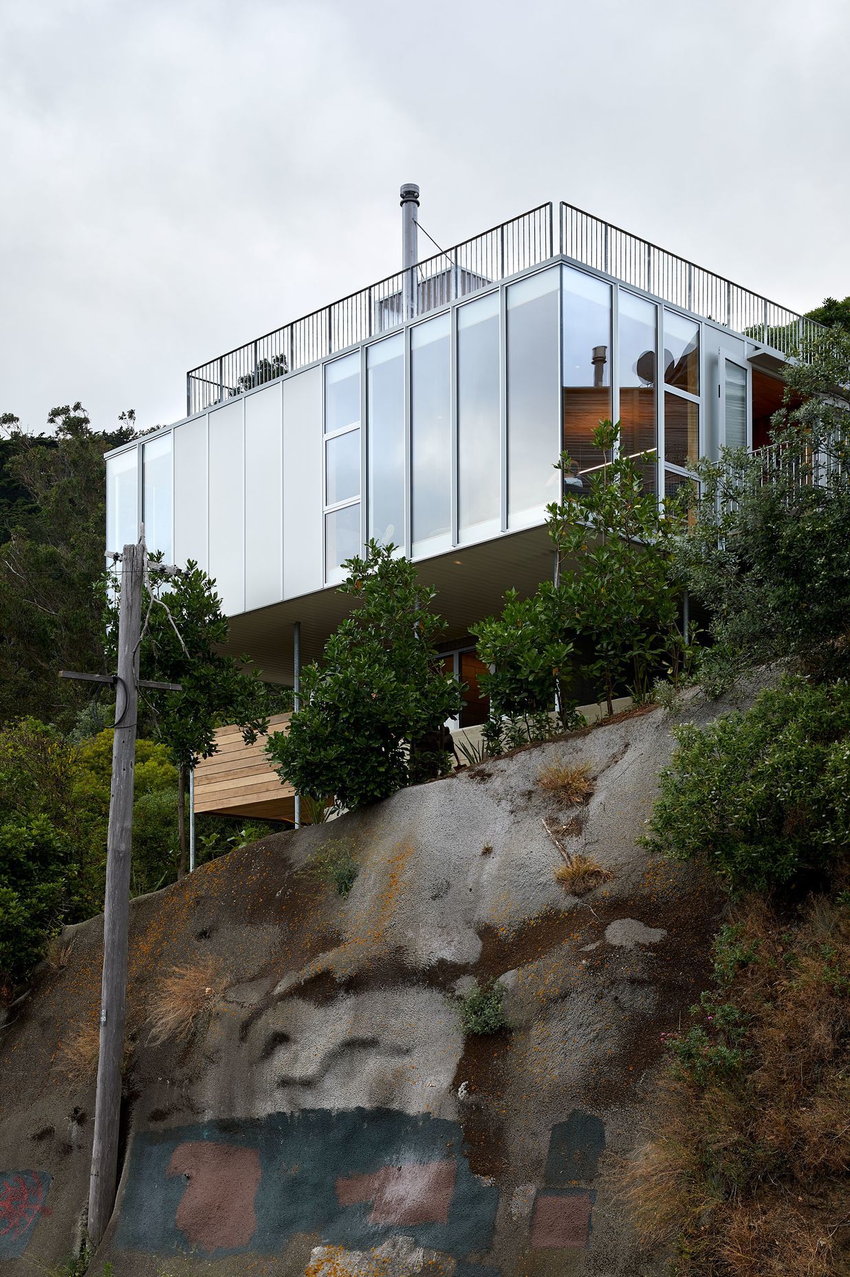 Patchwork Architecture's 100m² 10x10 House is supported on steel poles, with killer views of Wellington city. Photograph by Simon Wilson.