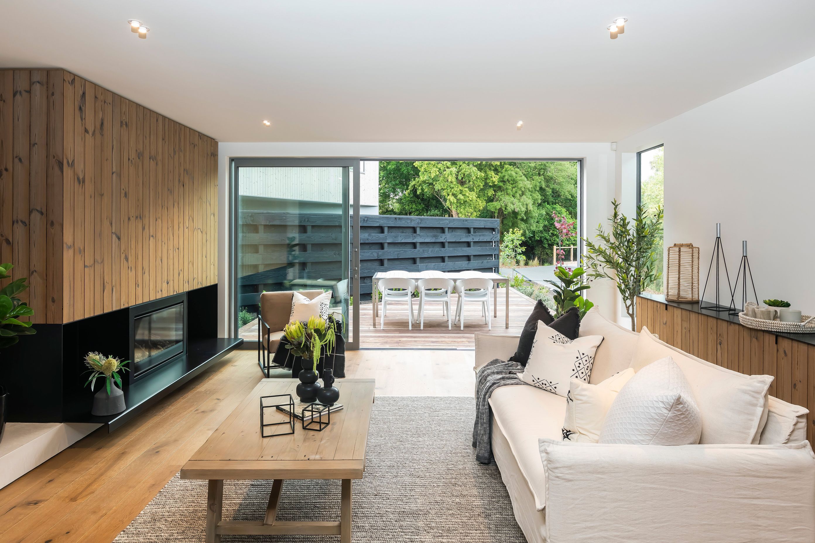A cosy sitting room flows toward a decked coutyard.