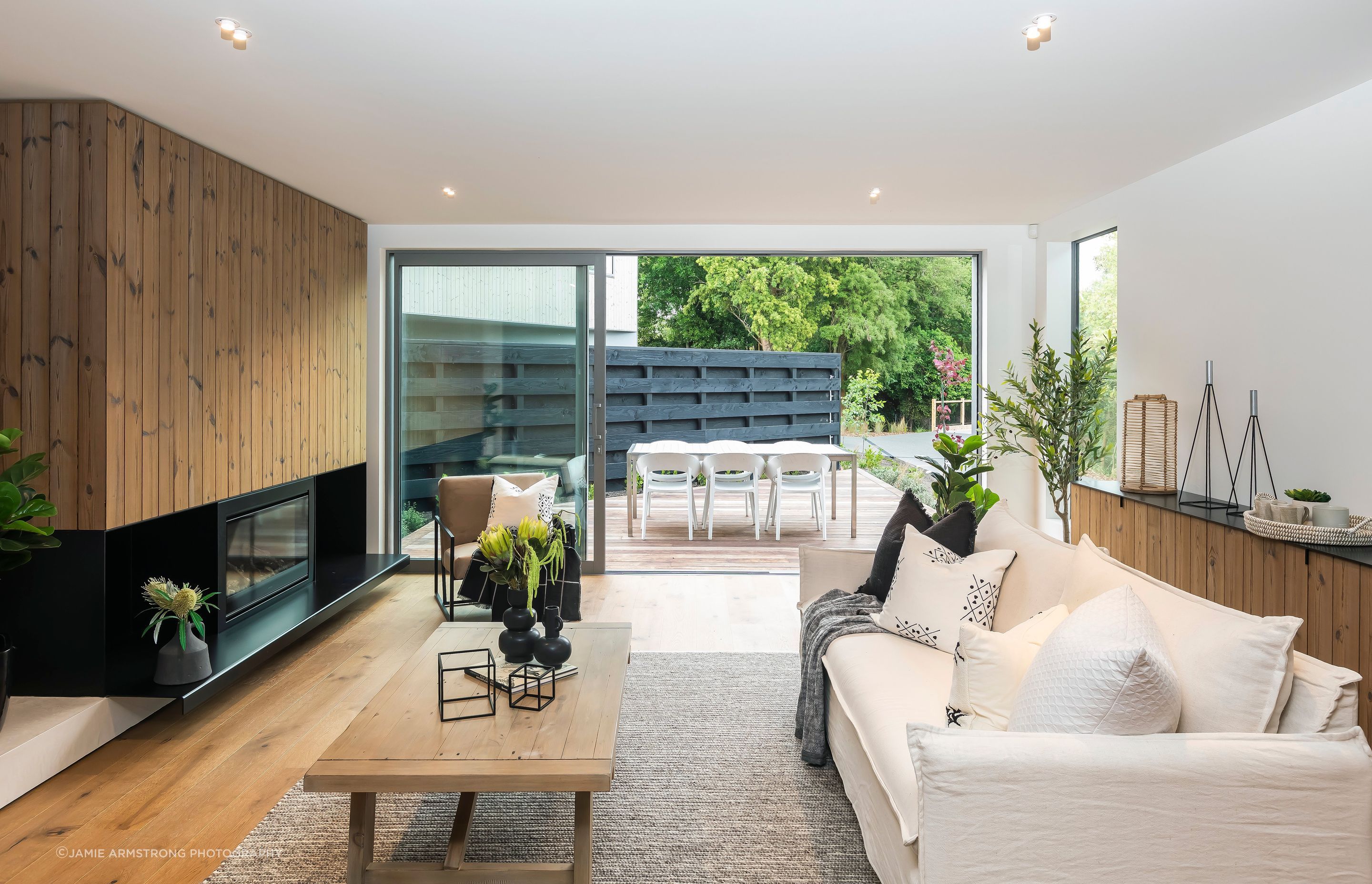 A cosy sitting room flows toward a decked coutyard.