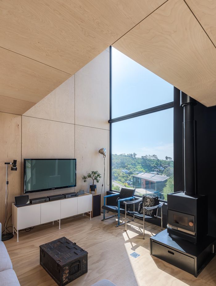 Meticulously lined up plywood panels frame the interior walls and ceiling.