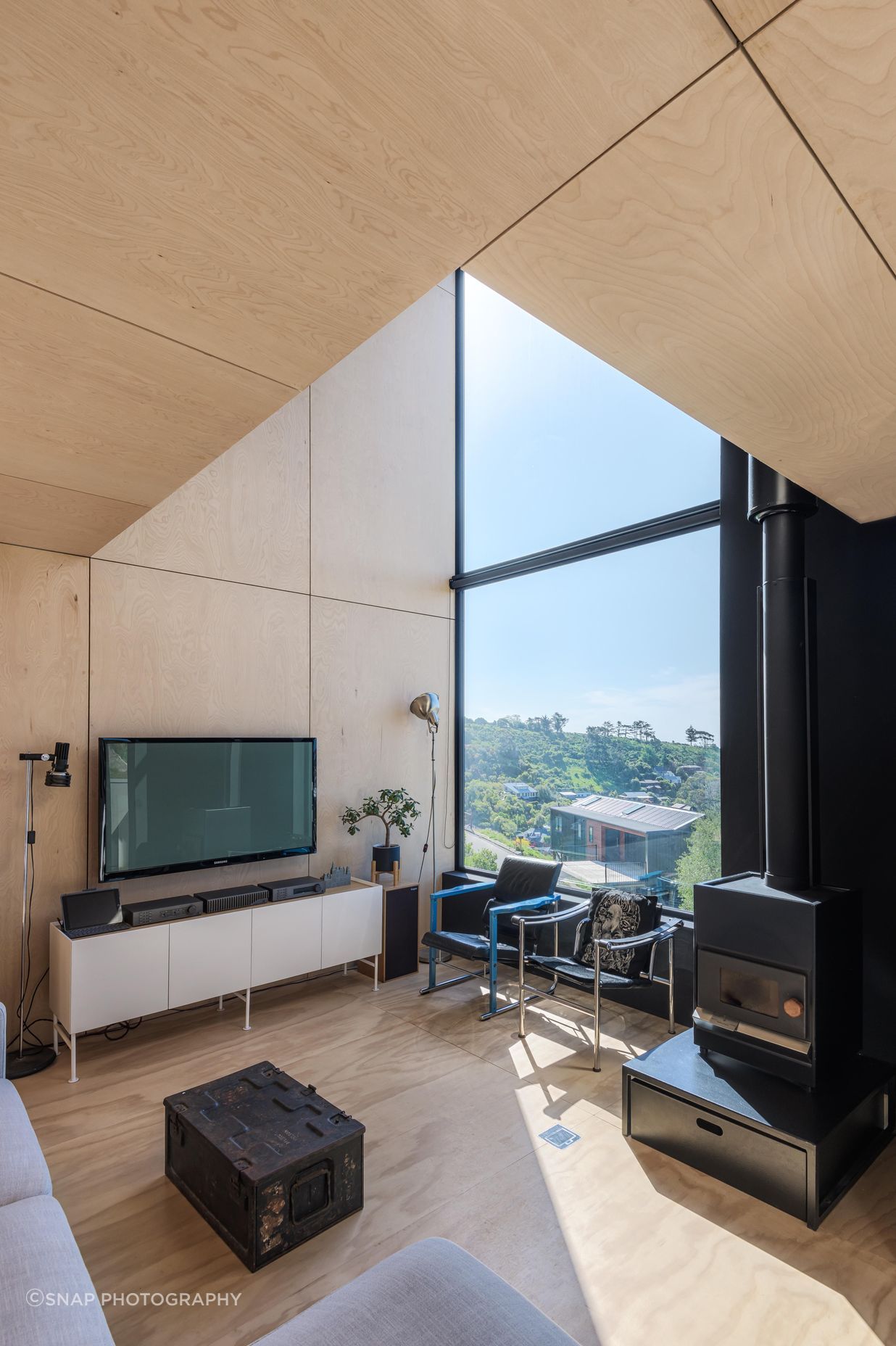 Meticulously lined up plywood panels frame the interior walls and ceiling.