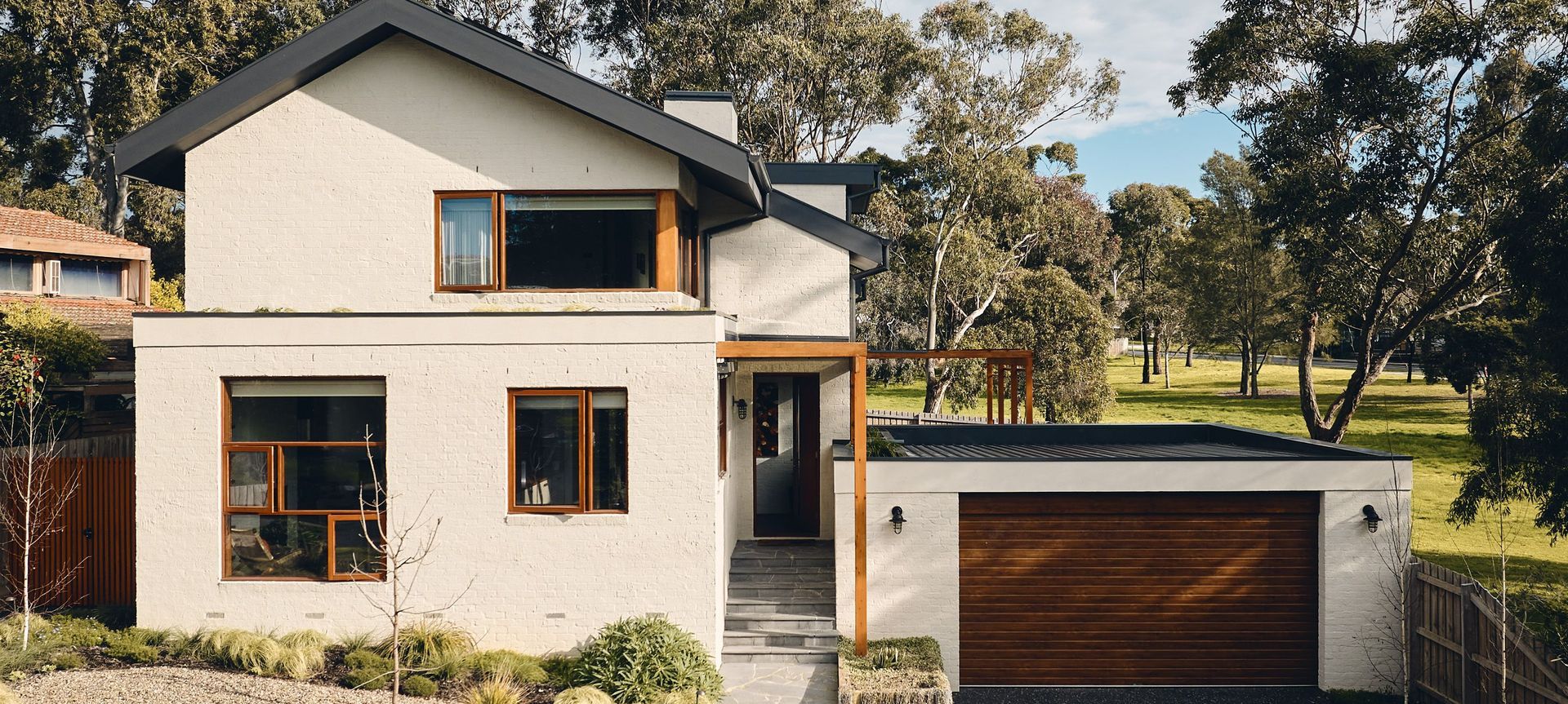 A home that directly overlooks the spectacular Dandenong Ranges in the distance, Hill House is bordered on both sides by the extensive public parkland of Wheelers Hill.