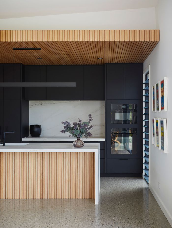 The black cabinetry adds mood and depth to the kitchen.