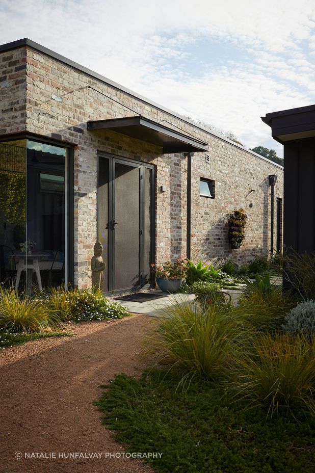 Landscaped gardens show the way to the studio.