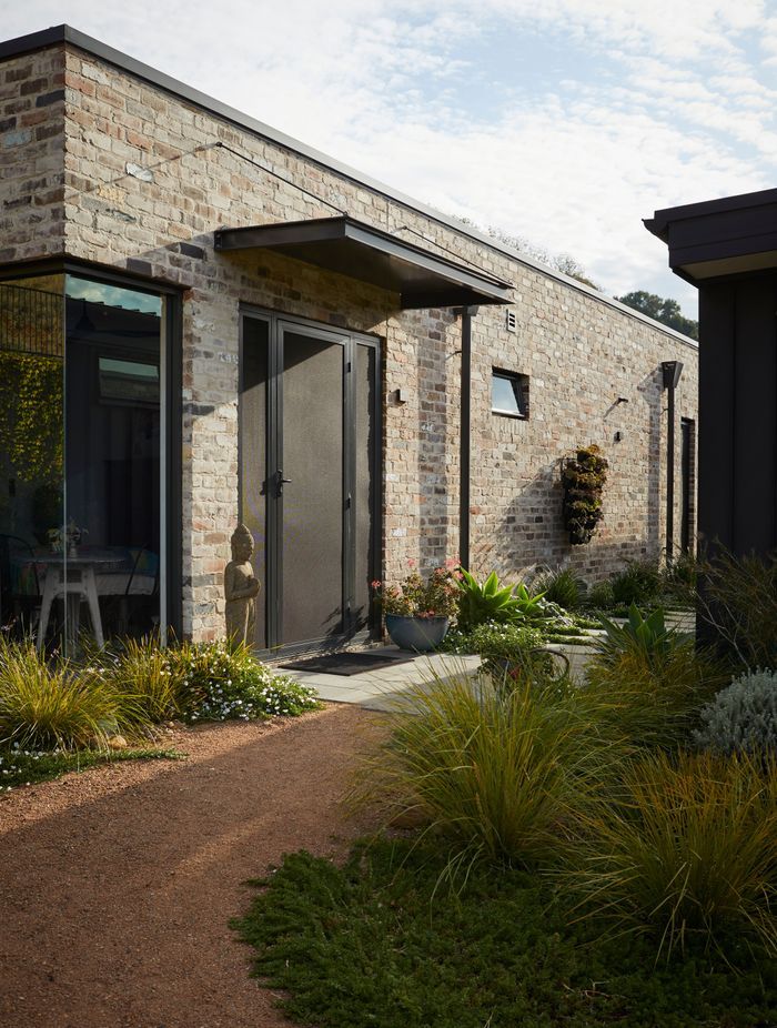 Landscaped gardens show the way to the studio.