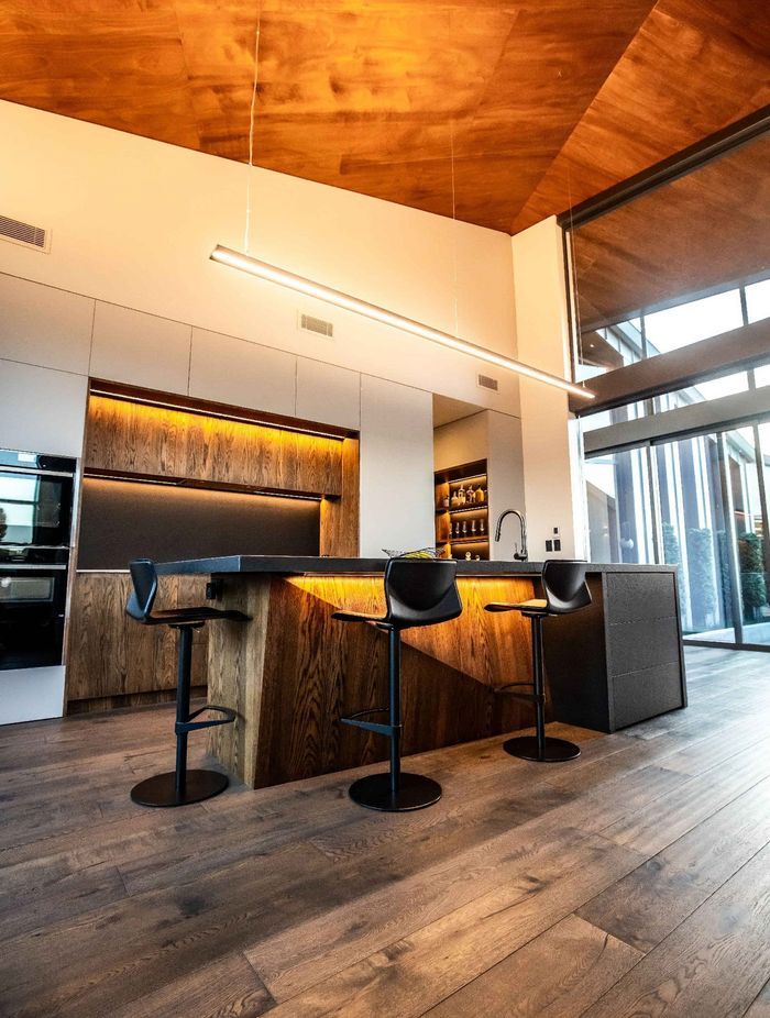 High ceilings clad in cedar create a visually striking and spacious interior.