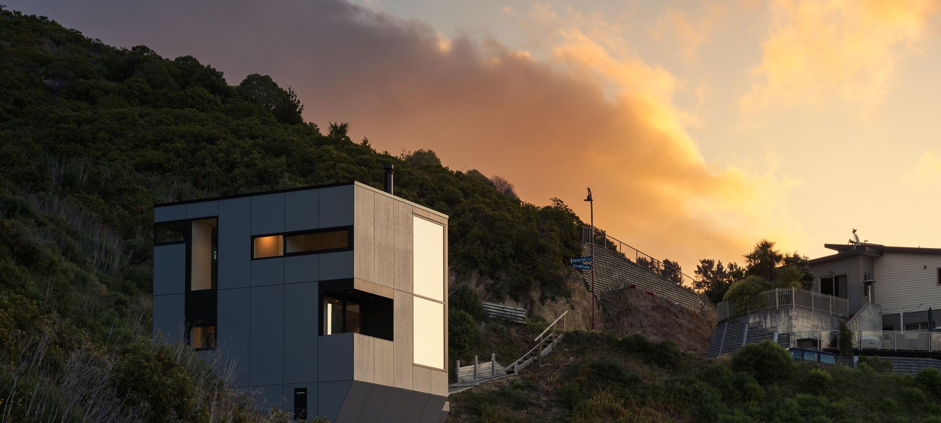 The rock-like formation of the home settles peacefully into the hillside. Image by Snap Photography