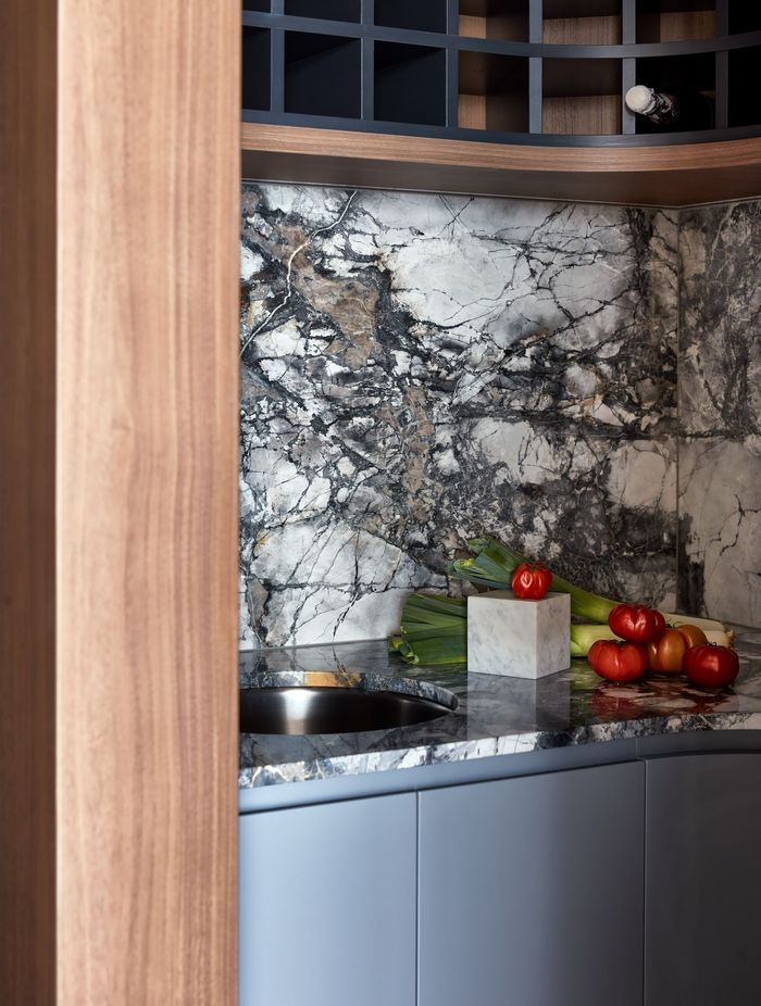 Blue-toned marble and walnut veneer suit the waterfront setting.