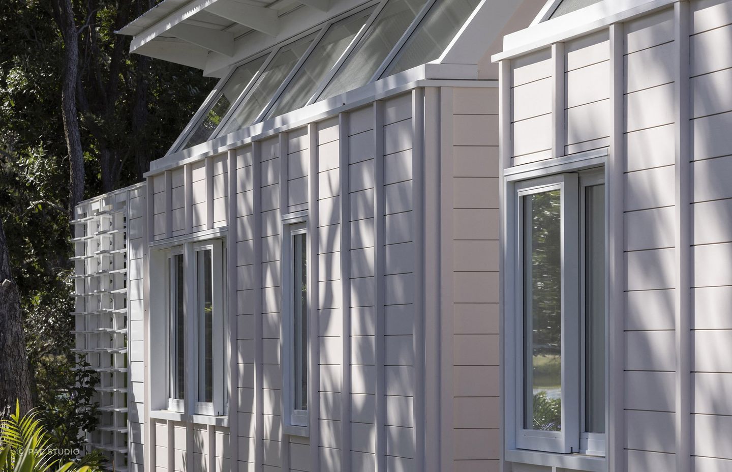 The blush pink exterior sits in harmony with the gardens