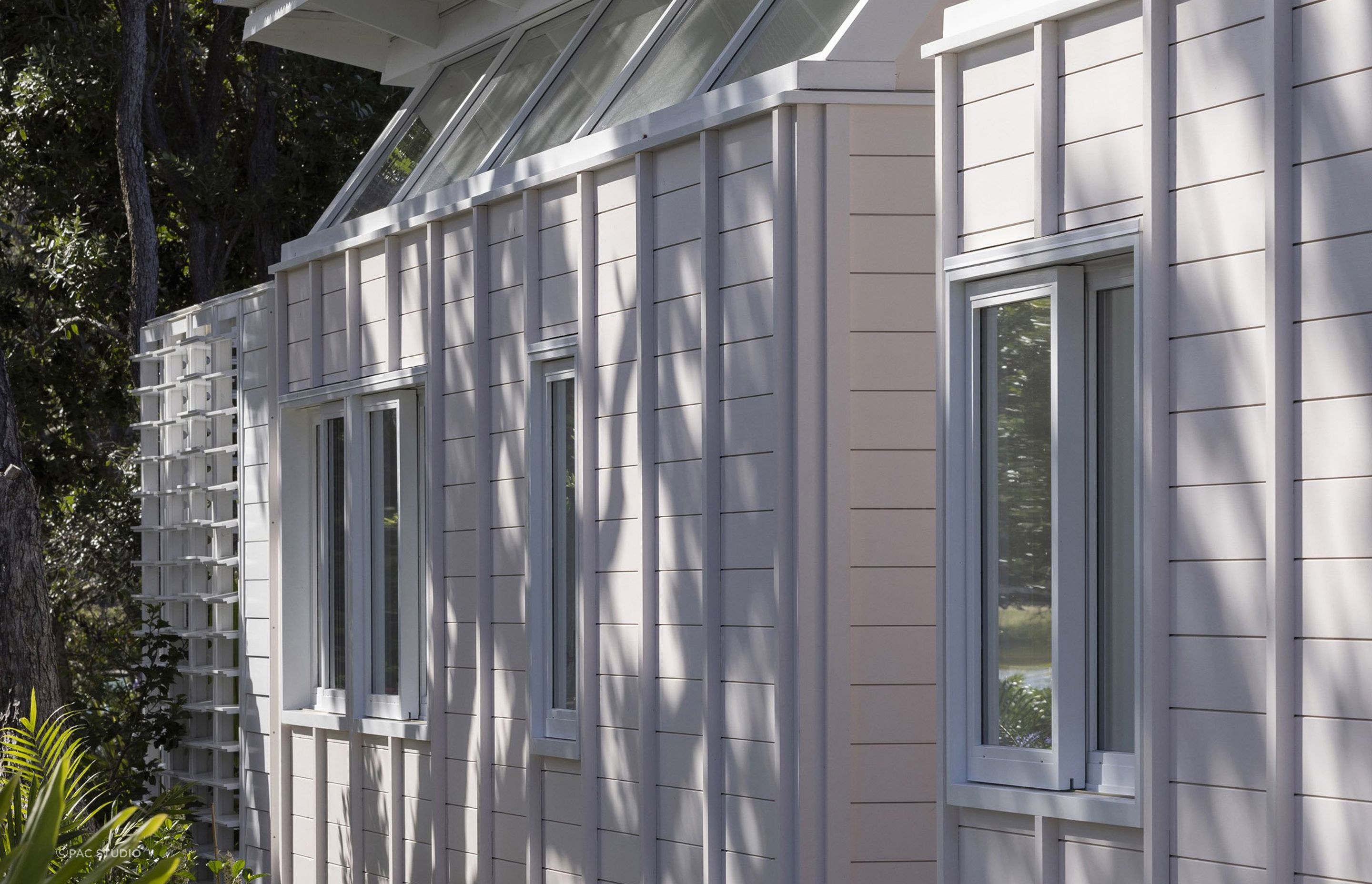 The blush pink exterior sits in harmony with the gardens