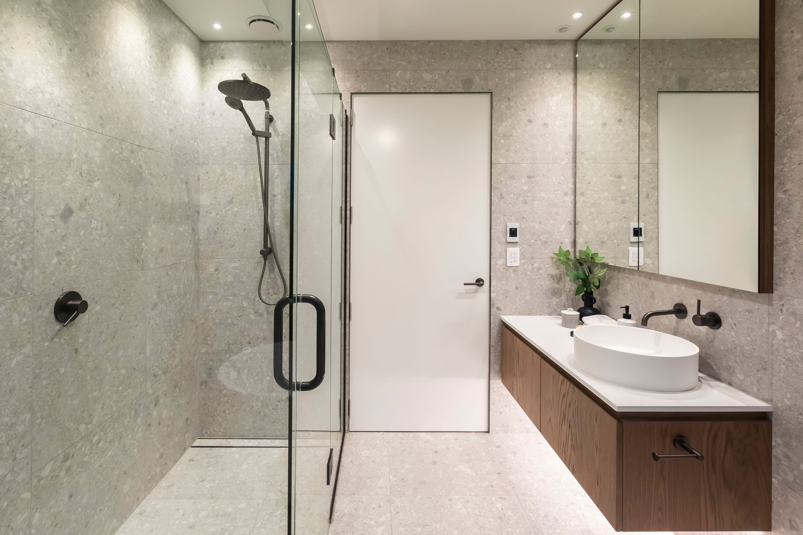 Floor to ceiling tiles add luxury to the bathrooms.