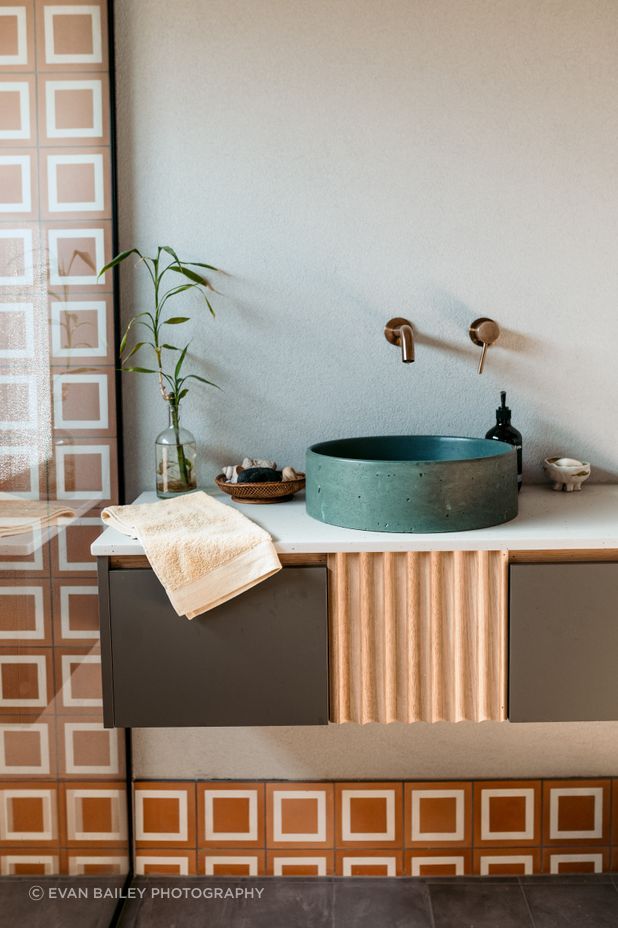 A rustic, eclectic style in the main bathroom fills the new build with character.