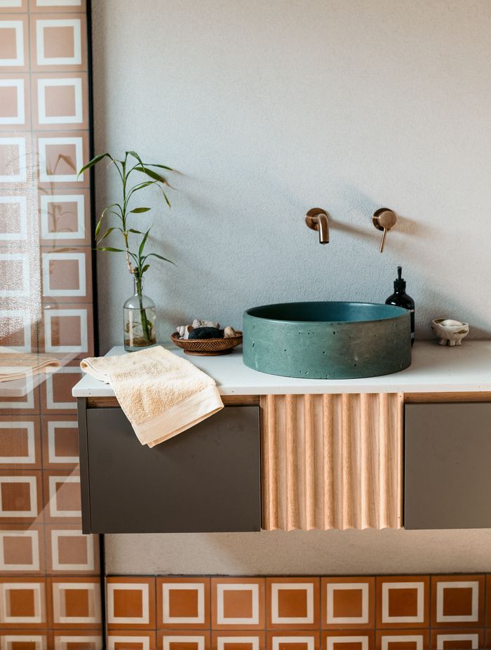 A rustic, eclectic style in the main bathroom fills the new build with character.