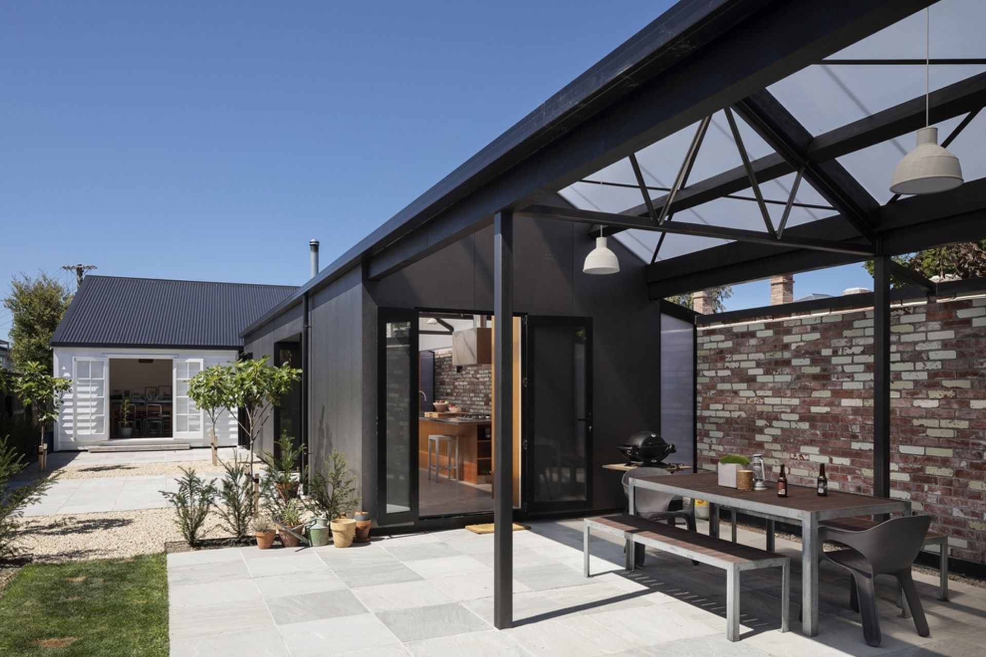 The gable roof is clad in polycarbonate to allow daylight and warmth into Amberley House's new addition.