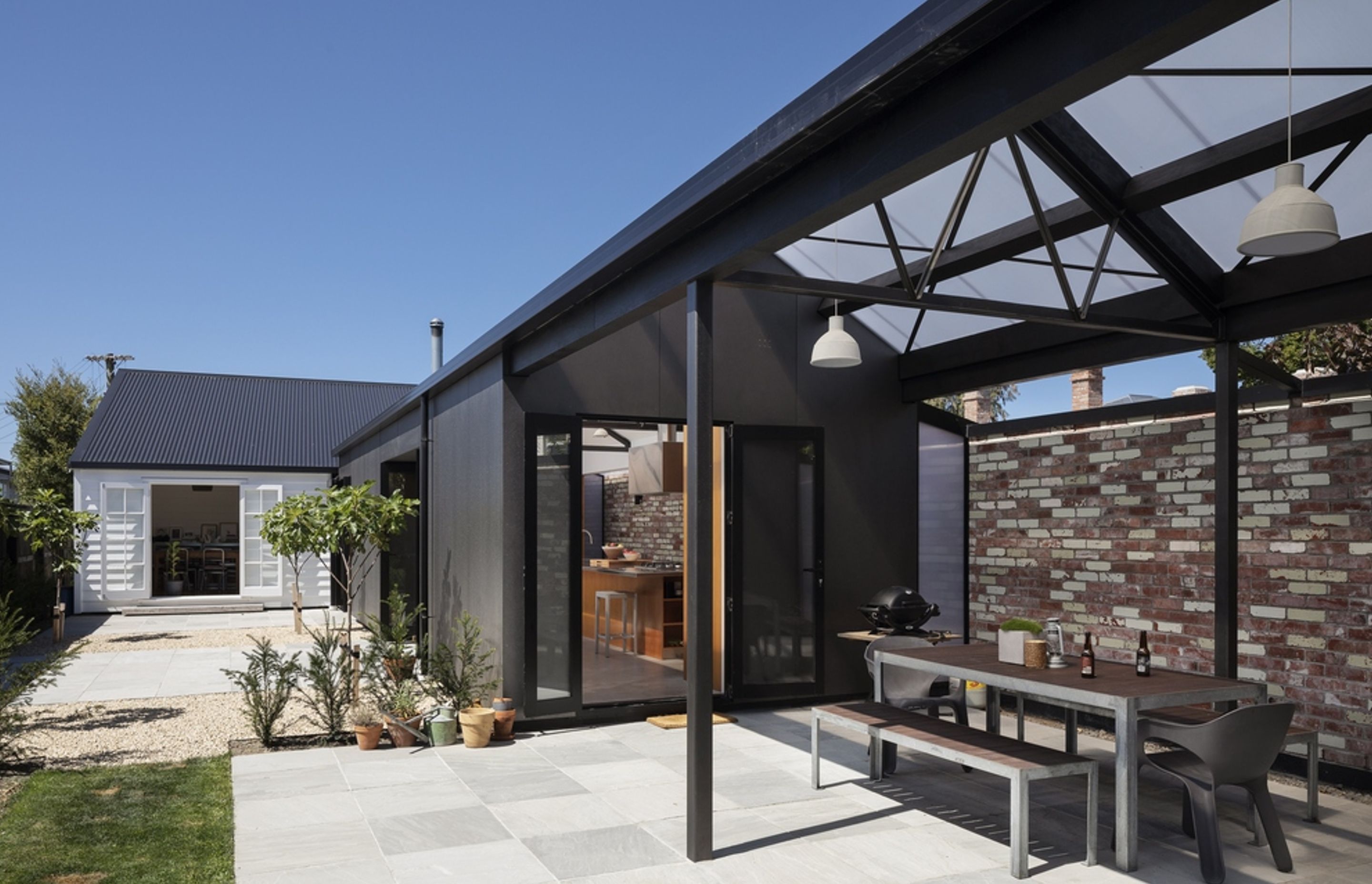 The gable roof is clad in polycarbonate to allow daylight and warmth into Amberley House's new addition.