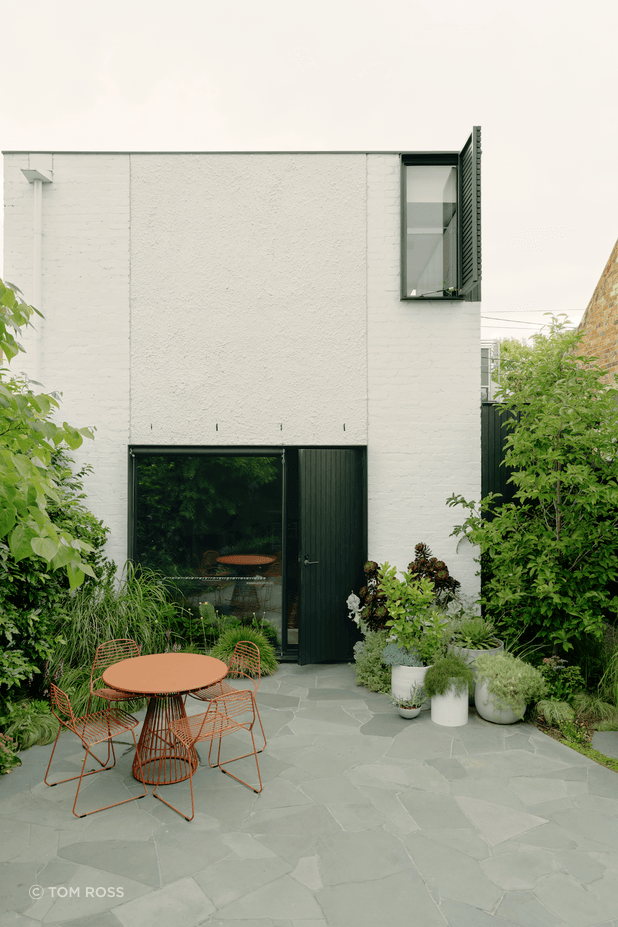 The green theme spills out into a light-filled courtyard abundant with greenery.