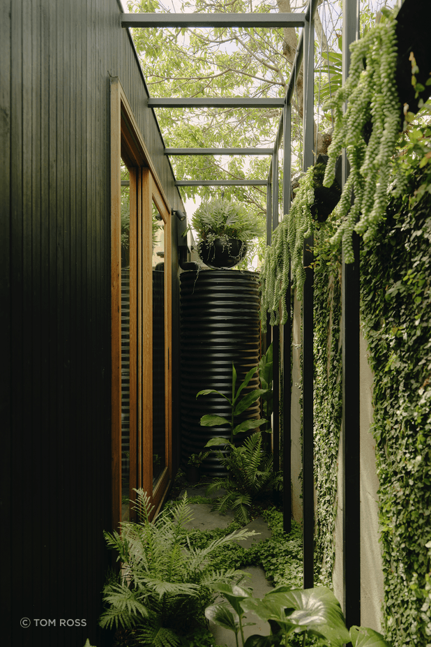 The striking project combines a whitewashed heritage terrace with a slick black extension to incredible monochromatic effect.