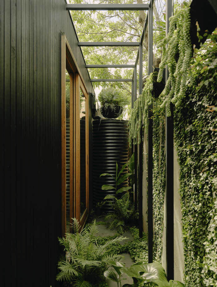 The striking project combines a whitewashed heritage terrace with a slick black extension to incredible monochromatic effect.