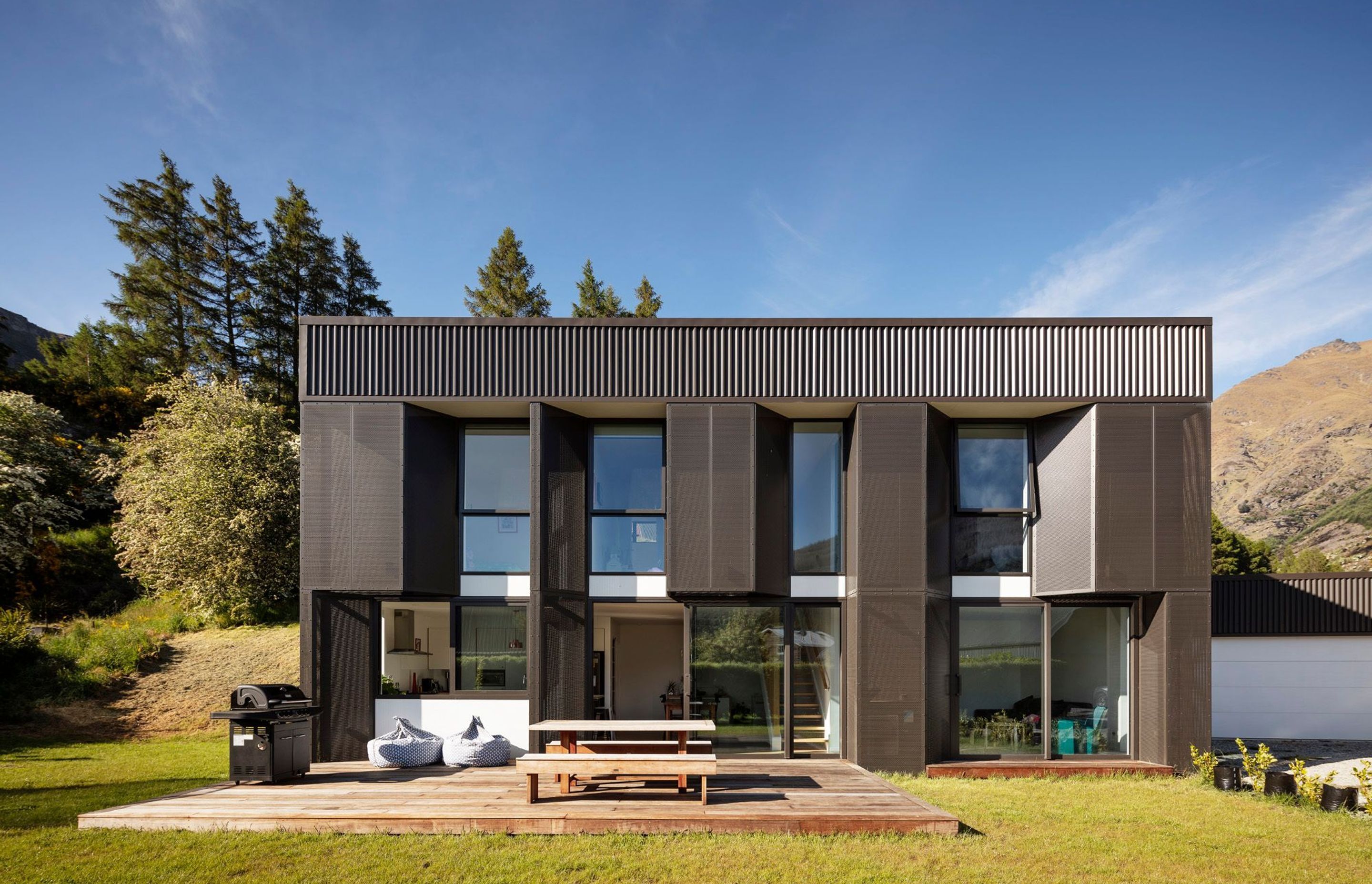 Built on a tight budget, mesh screens provide shading over low-E, double-glazed, thermally broken aluminium joinery on Arthurs Point Steel House by Team Green Architects. Photograph by Sam Hartnett.