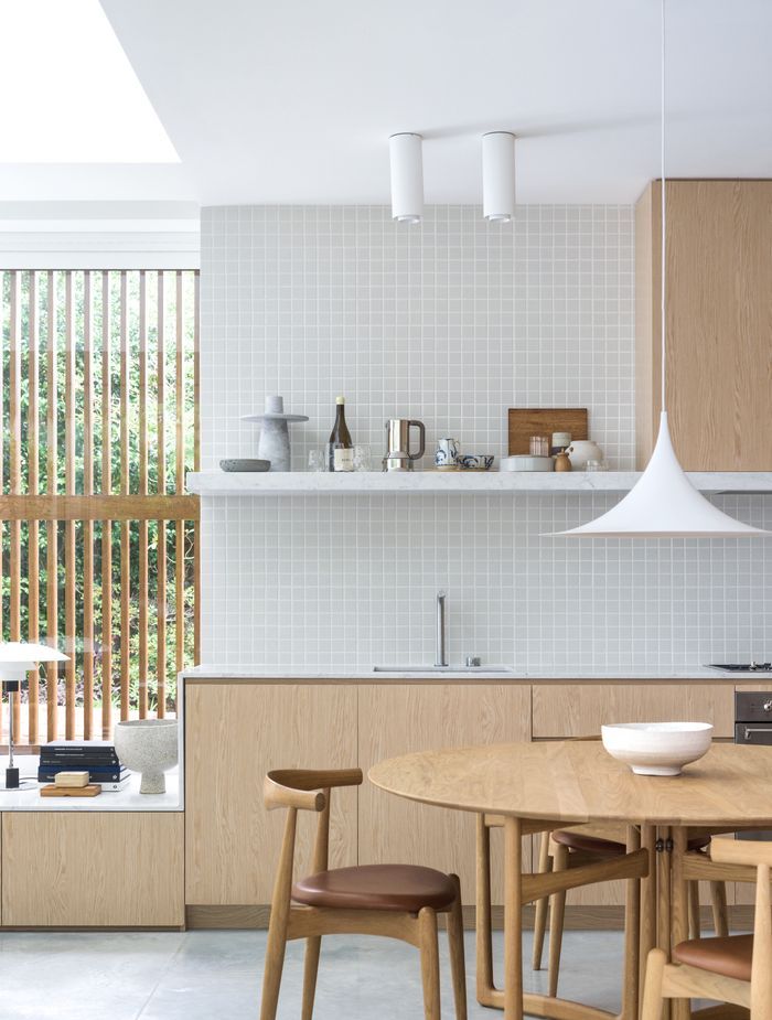 The kitchen merges into the window seat creating a seamless transition.