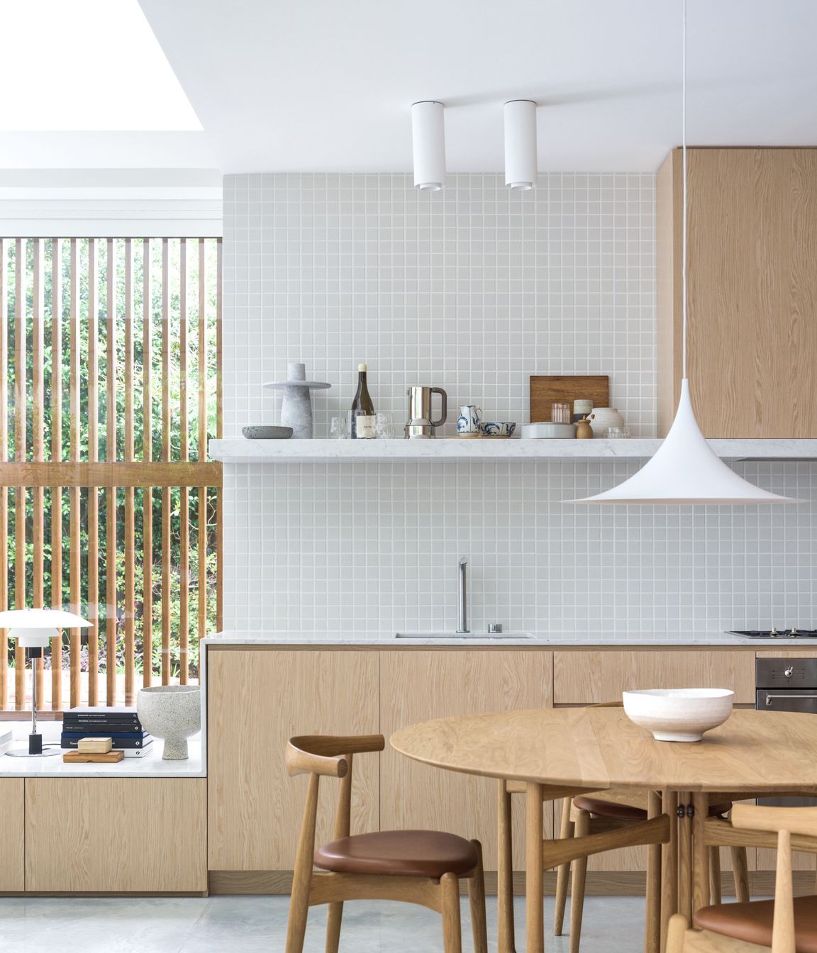 The kitchen merges into the window seat creating a seamless transition.