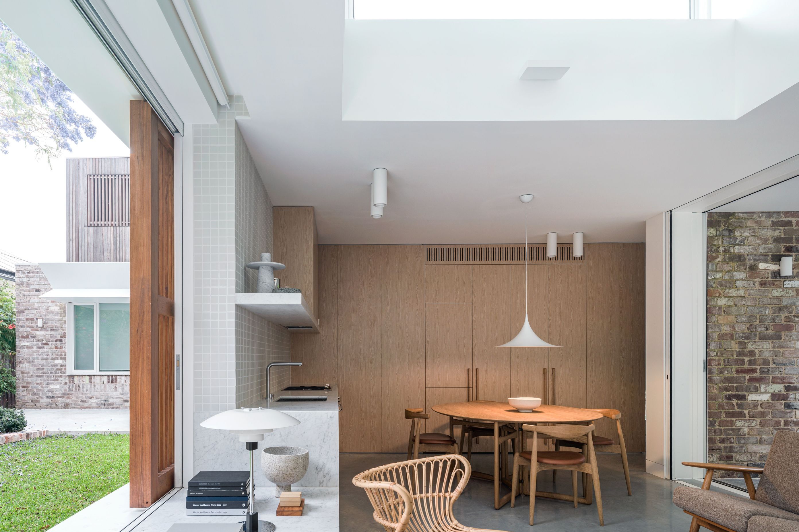 Appliances are integrated into the abundant floor-to-ceiling cabinetry.