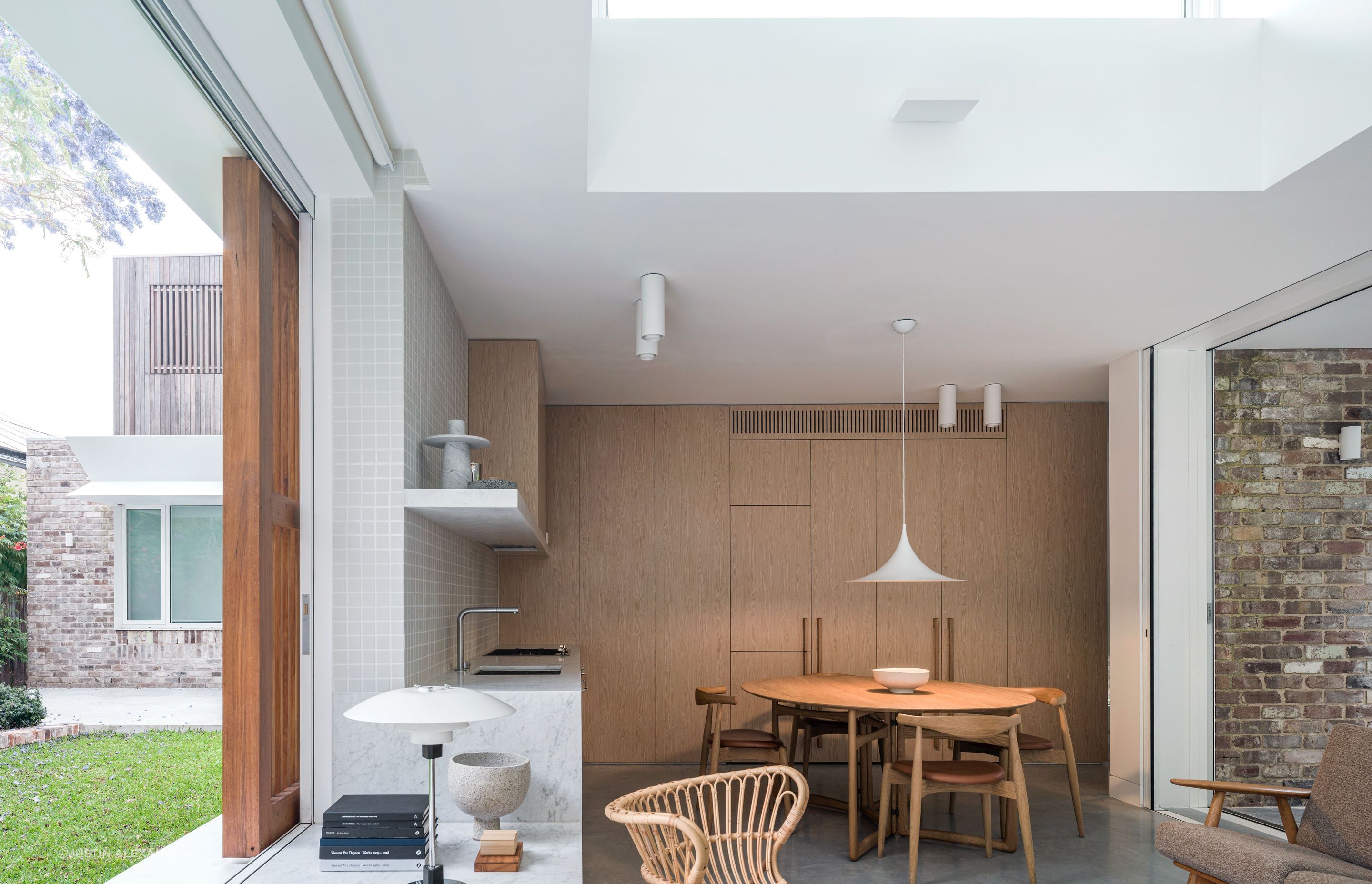 Appliances are integrated into the abundant floor-to-ceiling cabinetry.