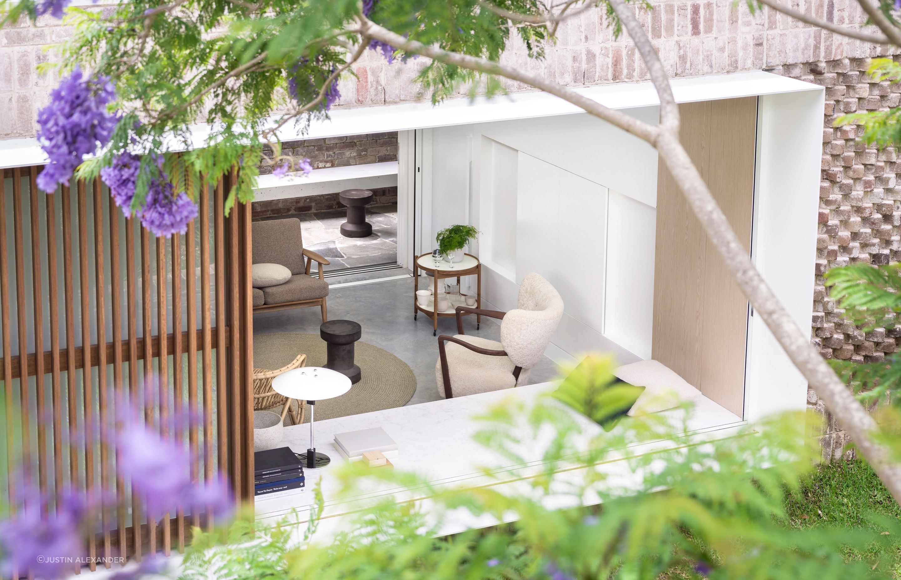 The home opens up to connect with the shared garden.