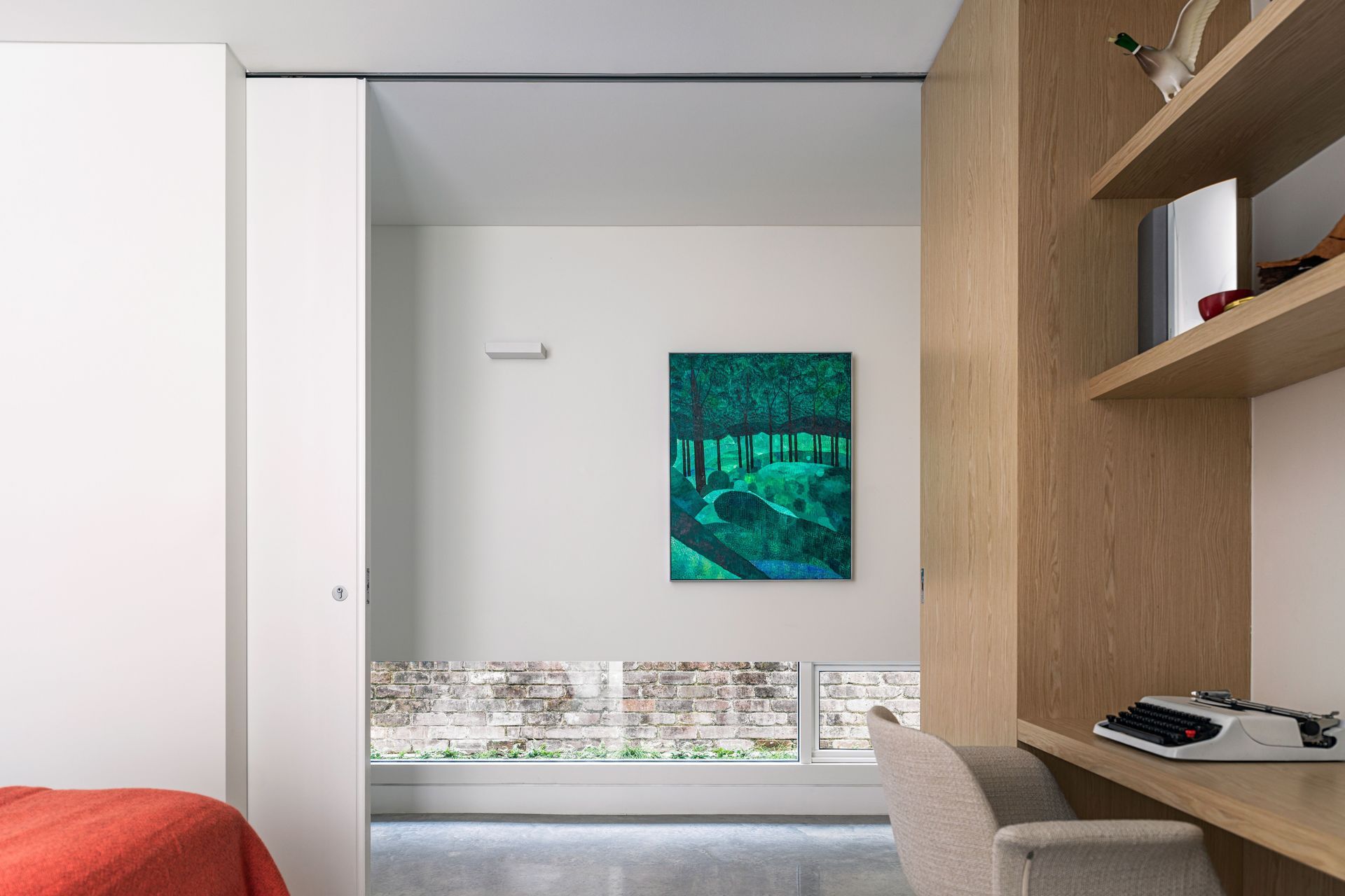 The hallway provides light and privacy with lowline windows to the yard.