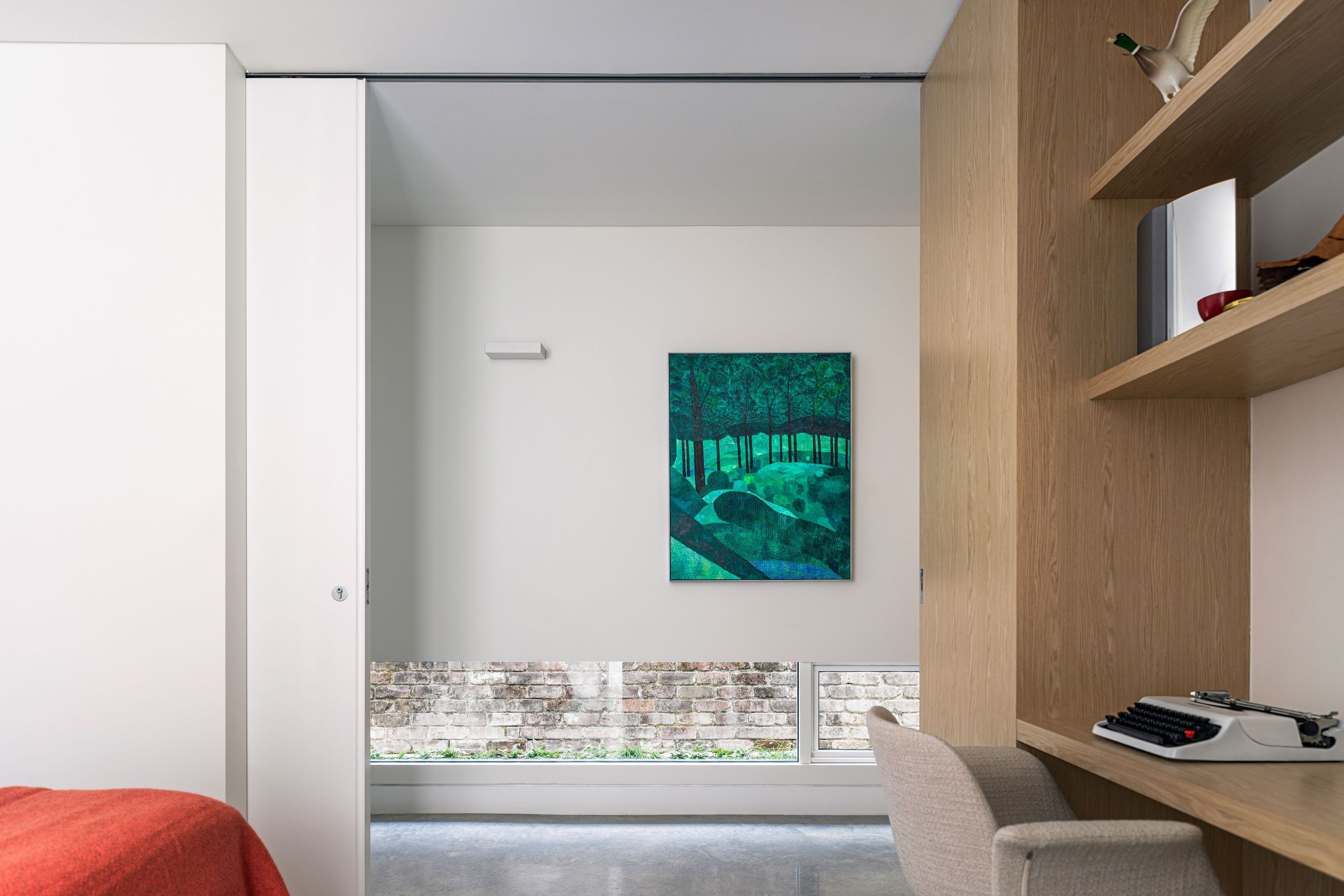 The hallway provides light and privacy with lowline windows to the yard.