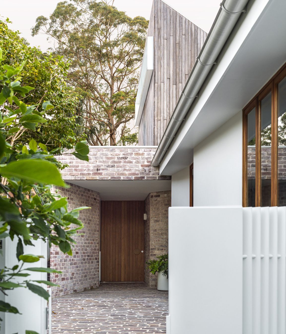 The dwelling has its own entrance via a canopy of brick work.