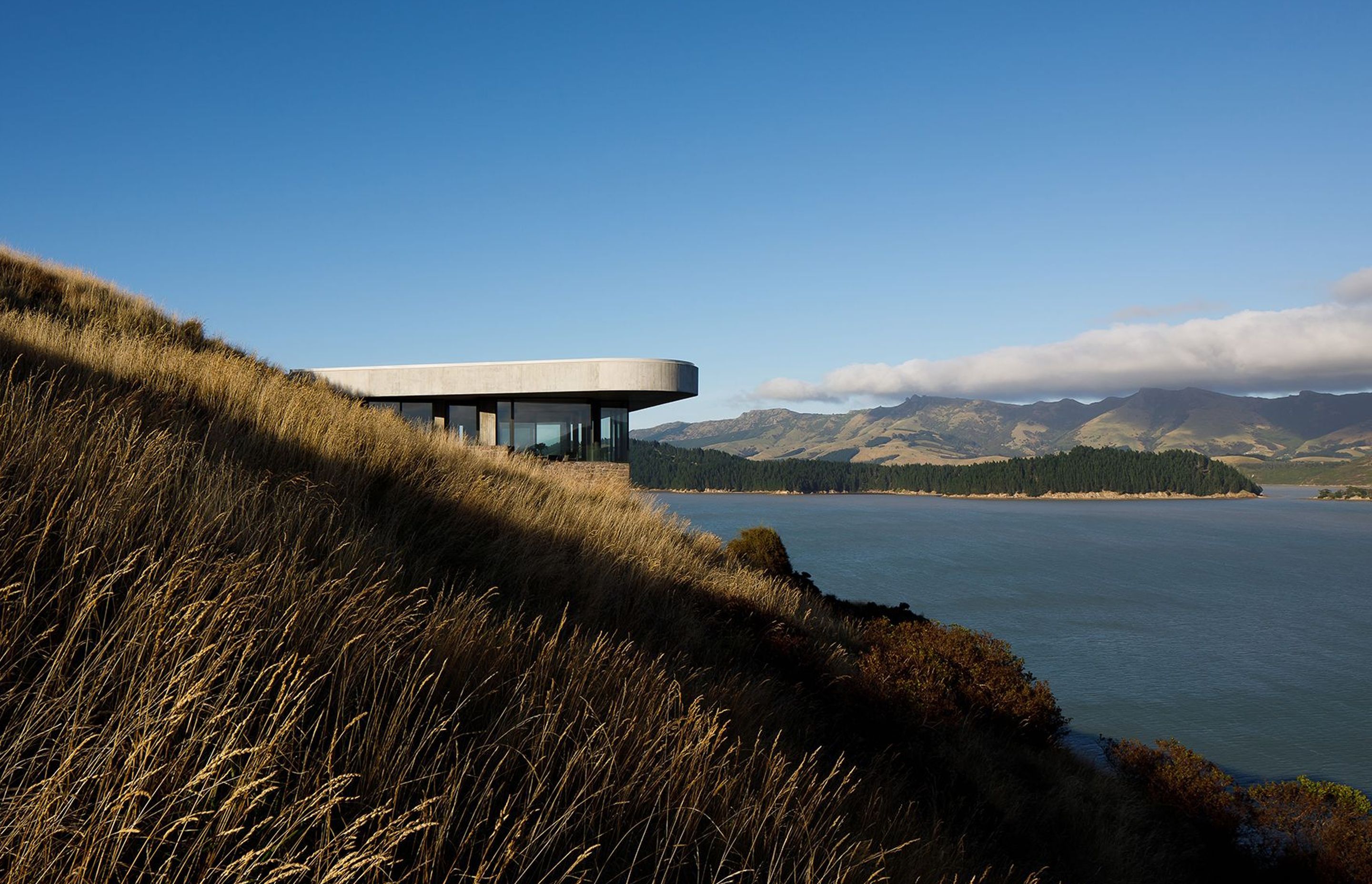 A large overhanging roof protects Black Rock House on the Banks Peninsula from strong sunlight on three sides.