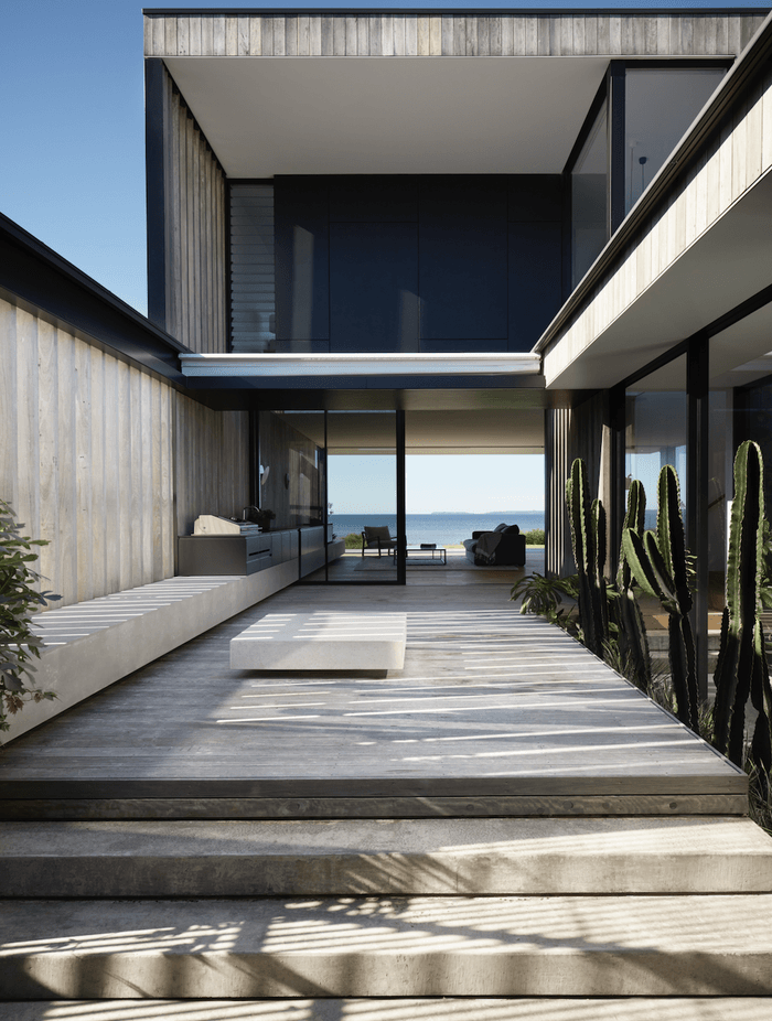 The exterior features pre-aged hardwood shiplap cladding.