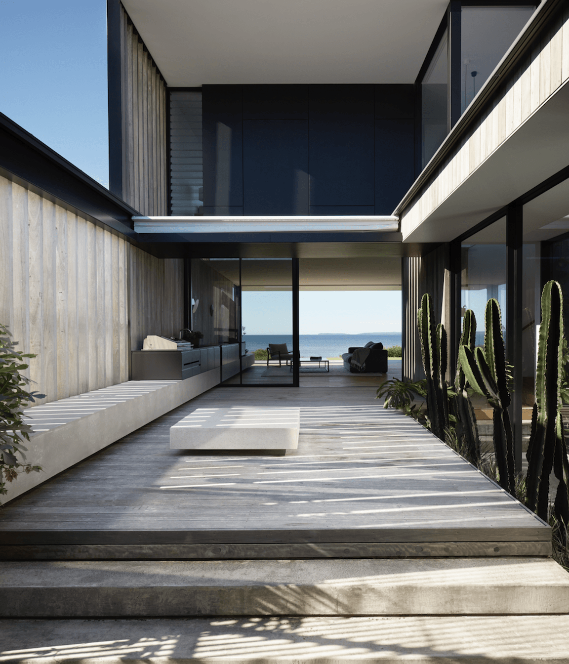 The exterior features pre-aged hardwood shiplap cladding.