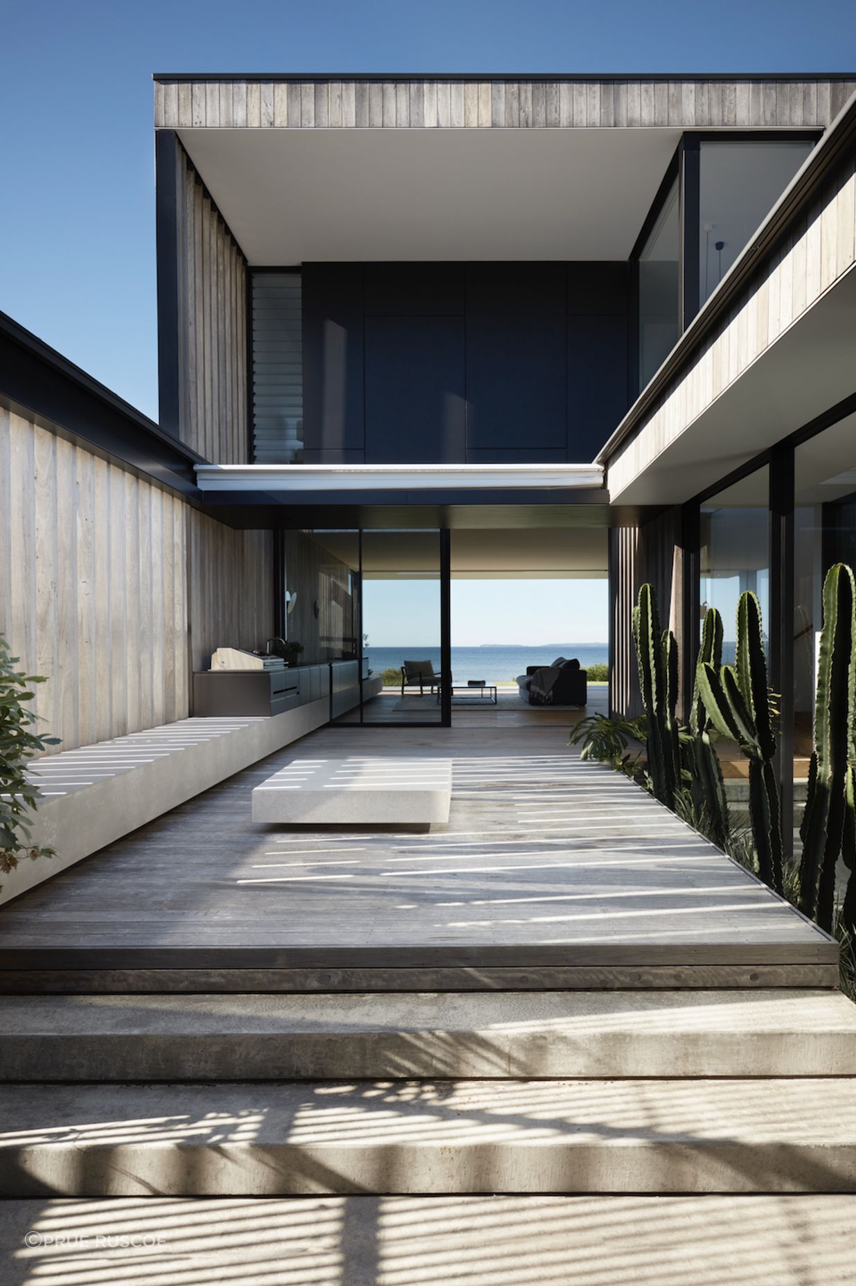 The exterior features pre-aged hardwood shiplap cladding.