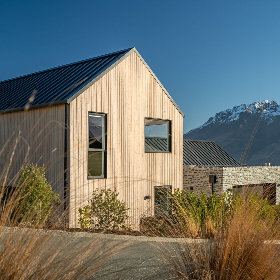 A gabled home framing mountain views in Queenstown banner