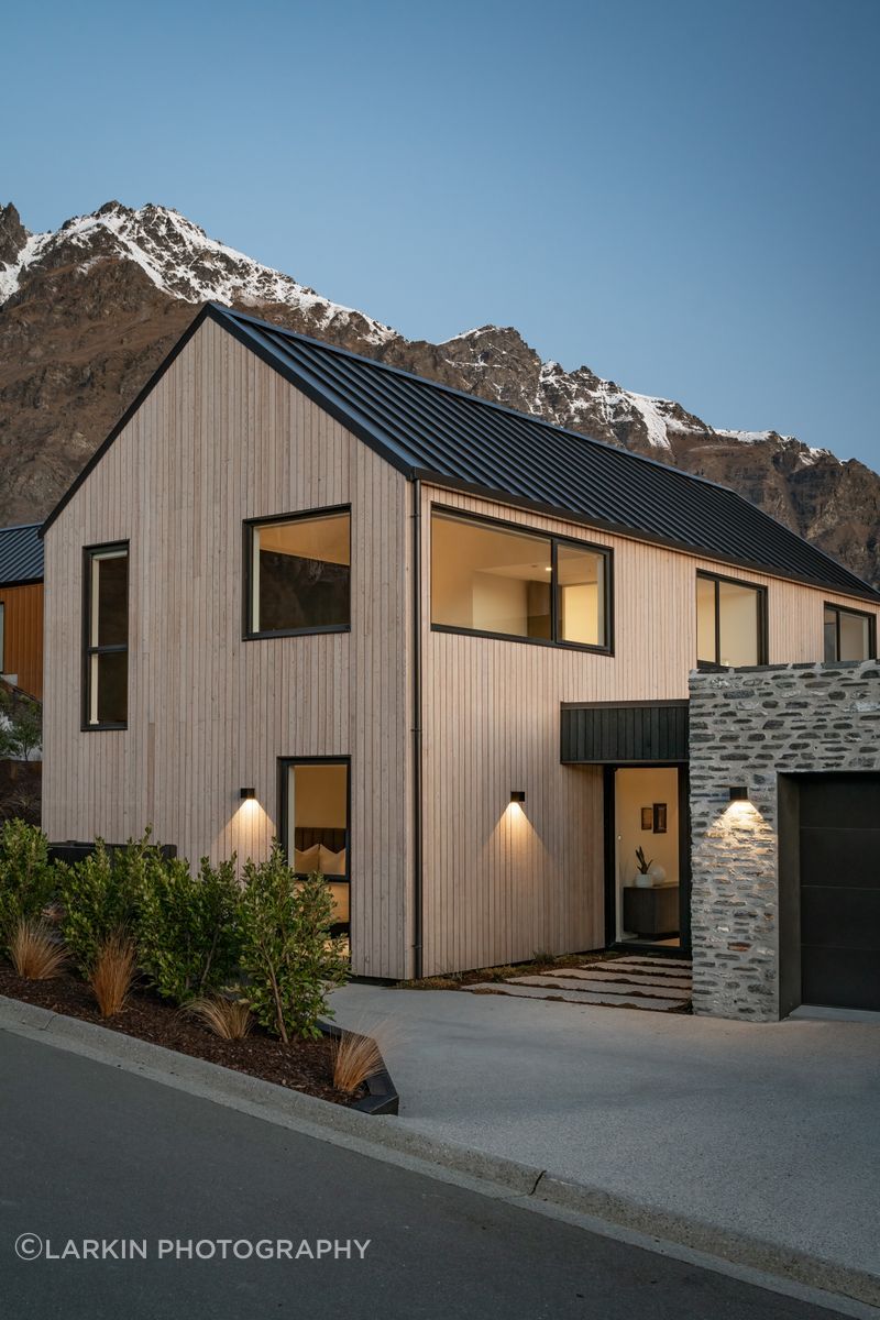 The minimal exterior showcasing vertical shiplap timber and Glenorchy schist.