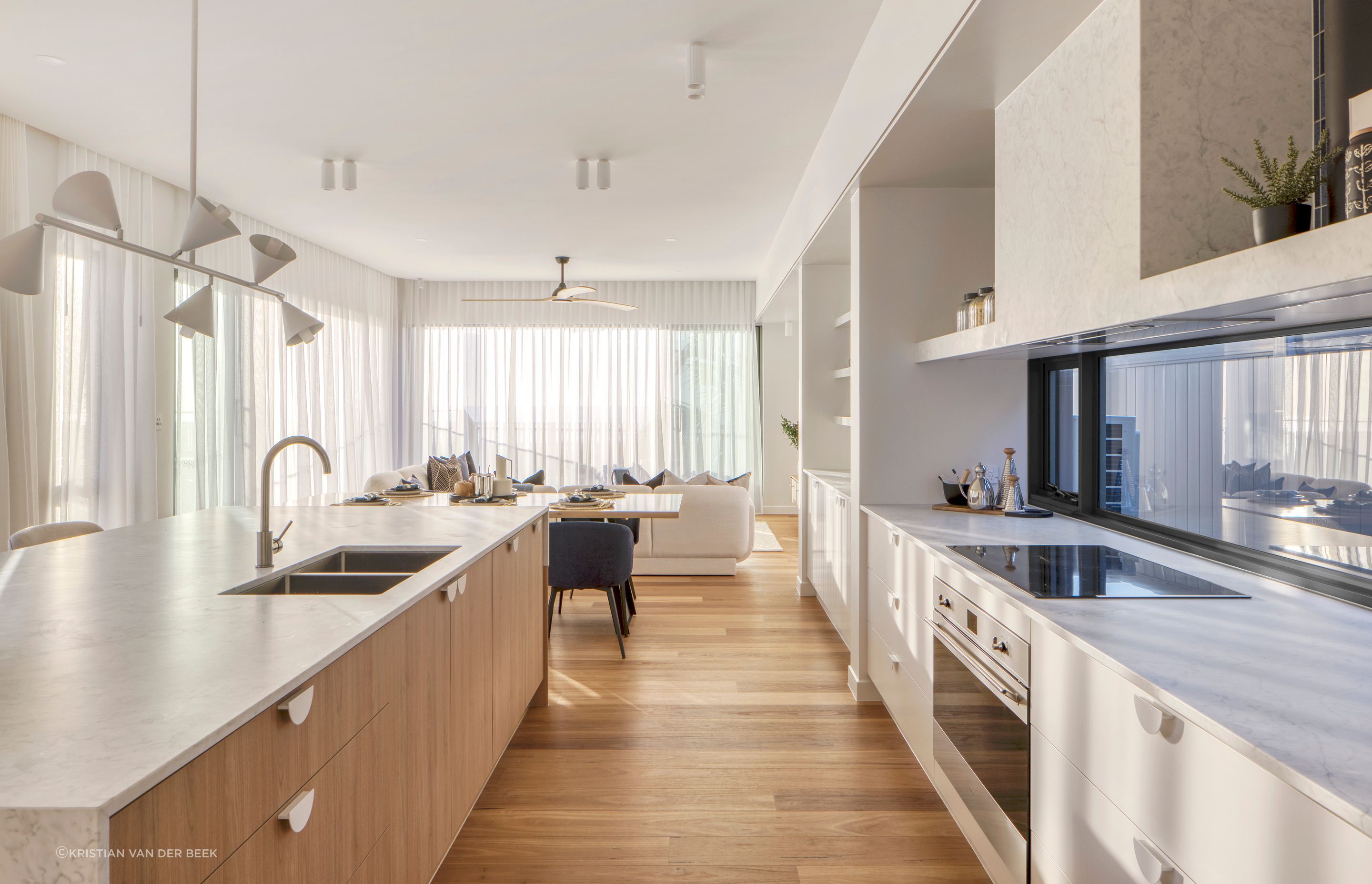 A neutral colour palette links the downstairs living spaces | Currumbin Beach House by Habitat Studio Architects