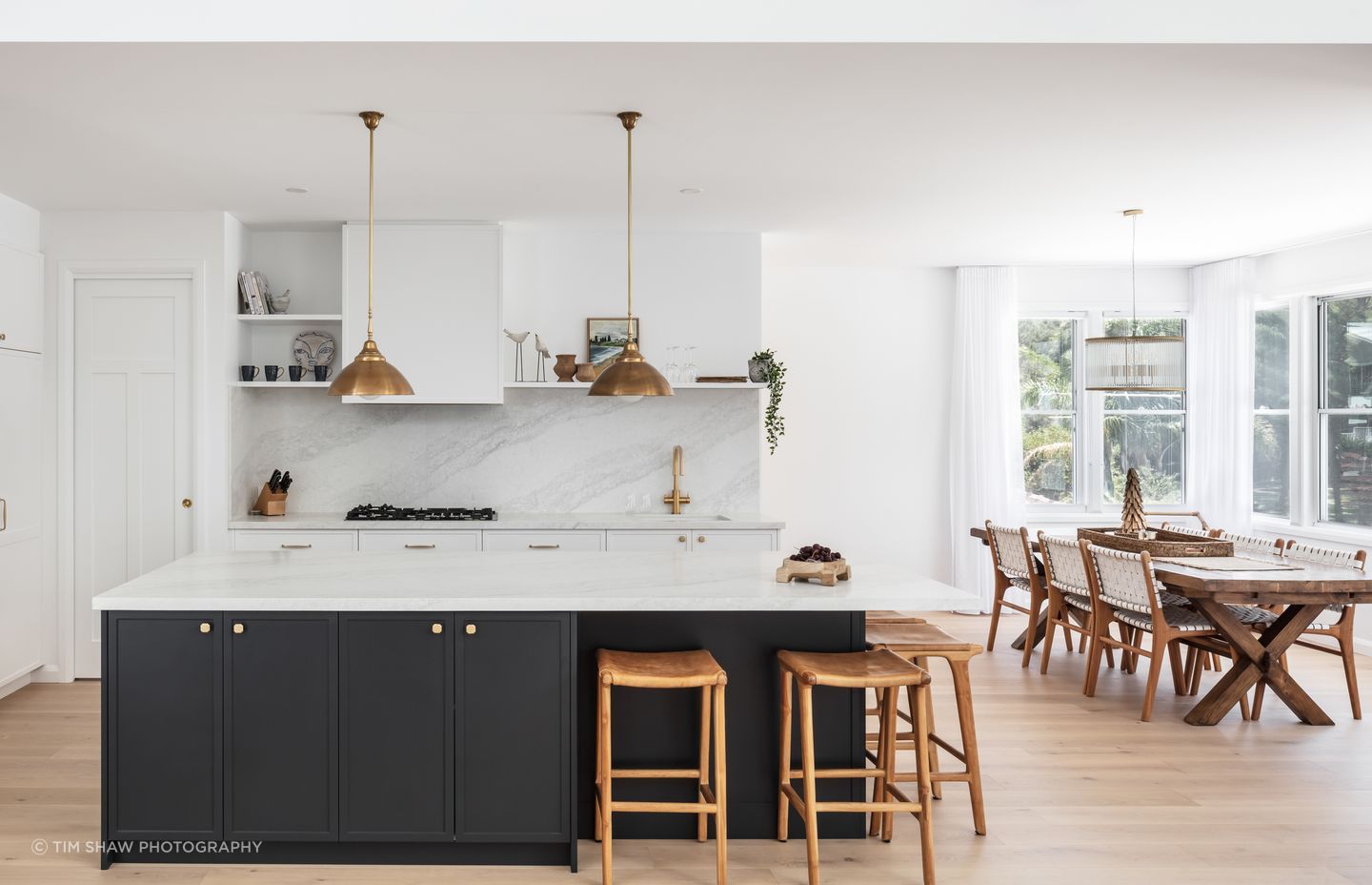 Dark cabinetry adds depth to the light, muted tones.