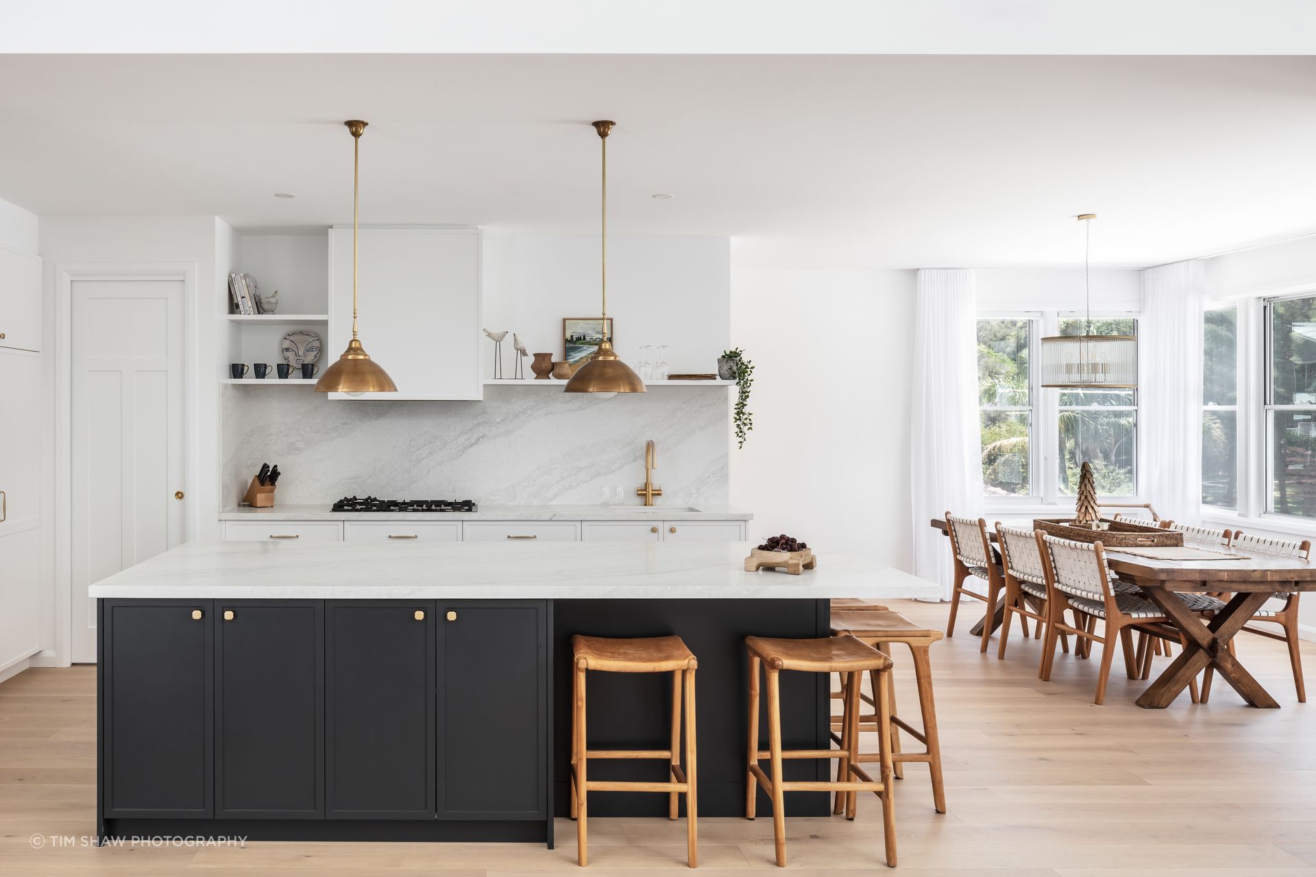 Dark cabinetry adds depth to the light, muted tones.