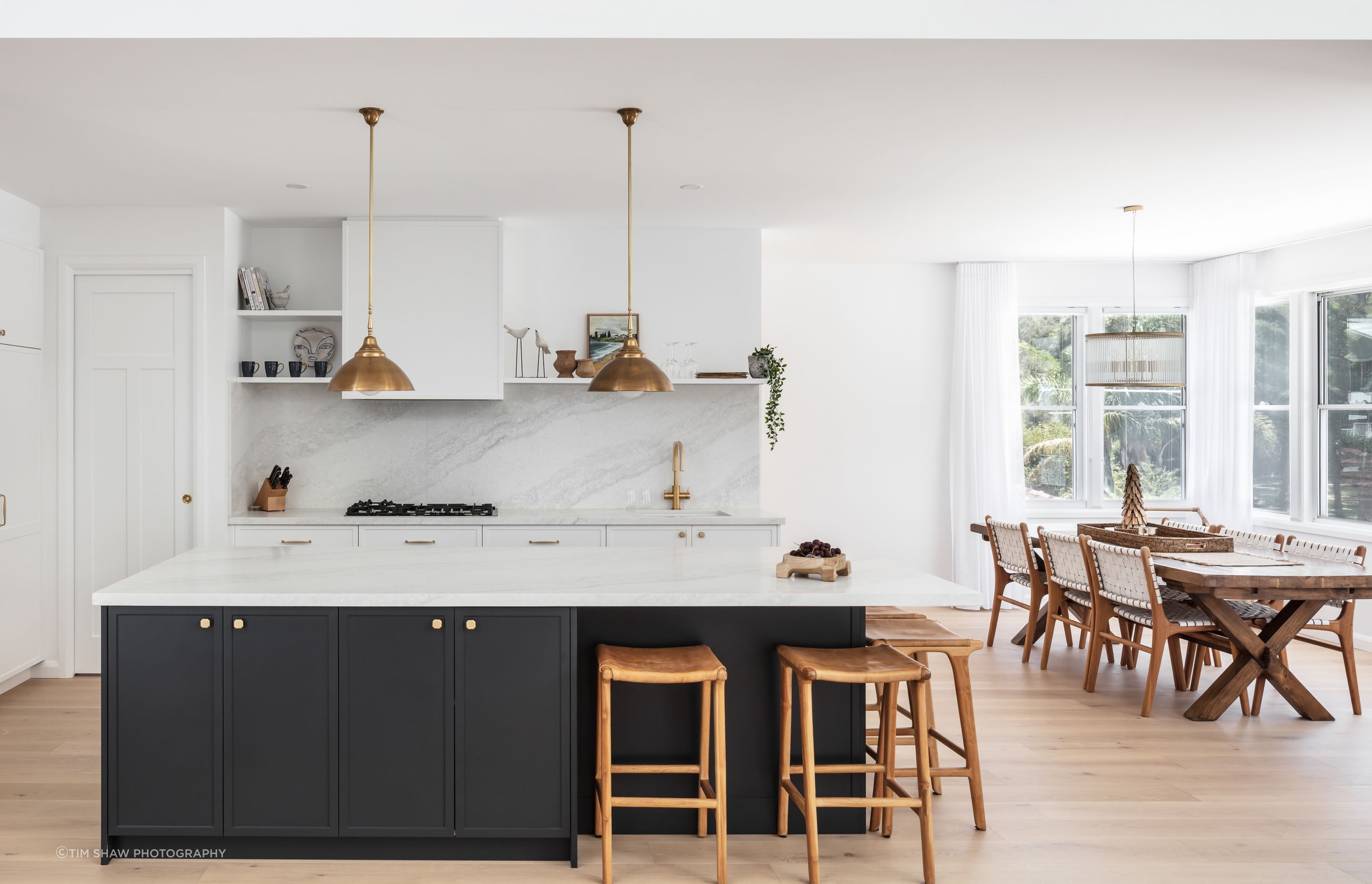 Dark cabinetry adds depth to the light, muted tones.