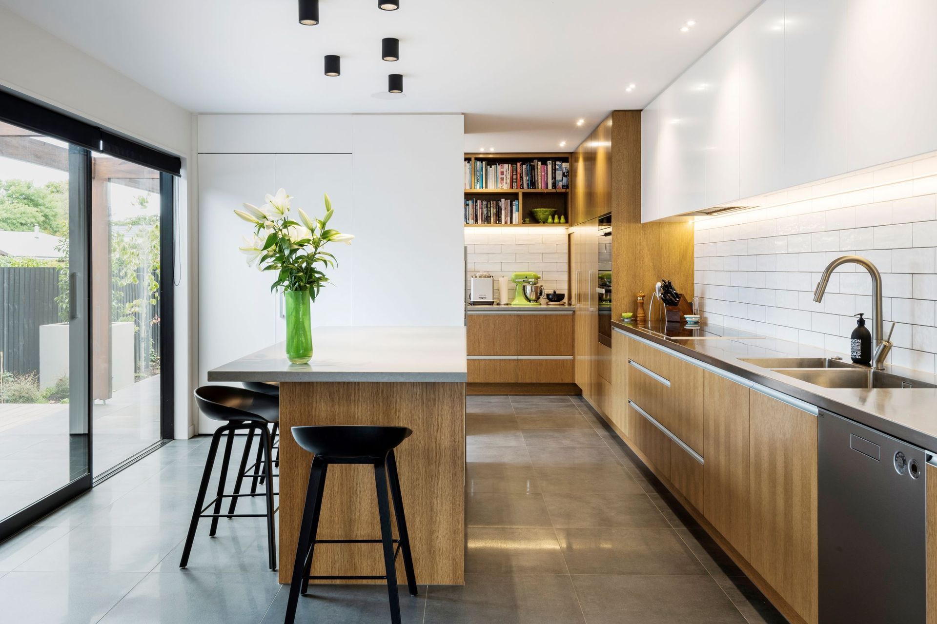 The sophisticated kitchen features a scullery and careful, minimalist detailing.