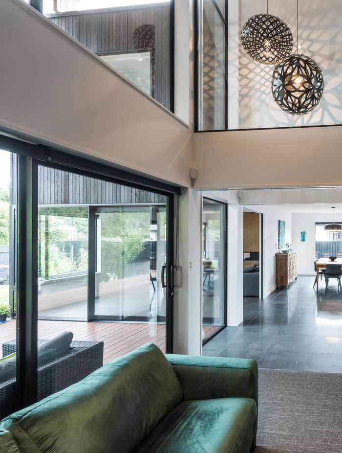 Inside the home, a double-height void features extensive glazing