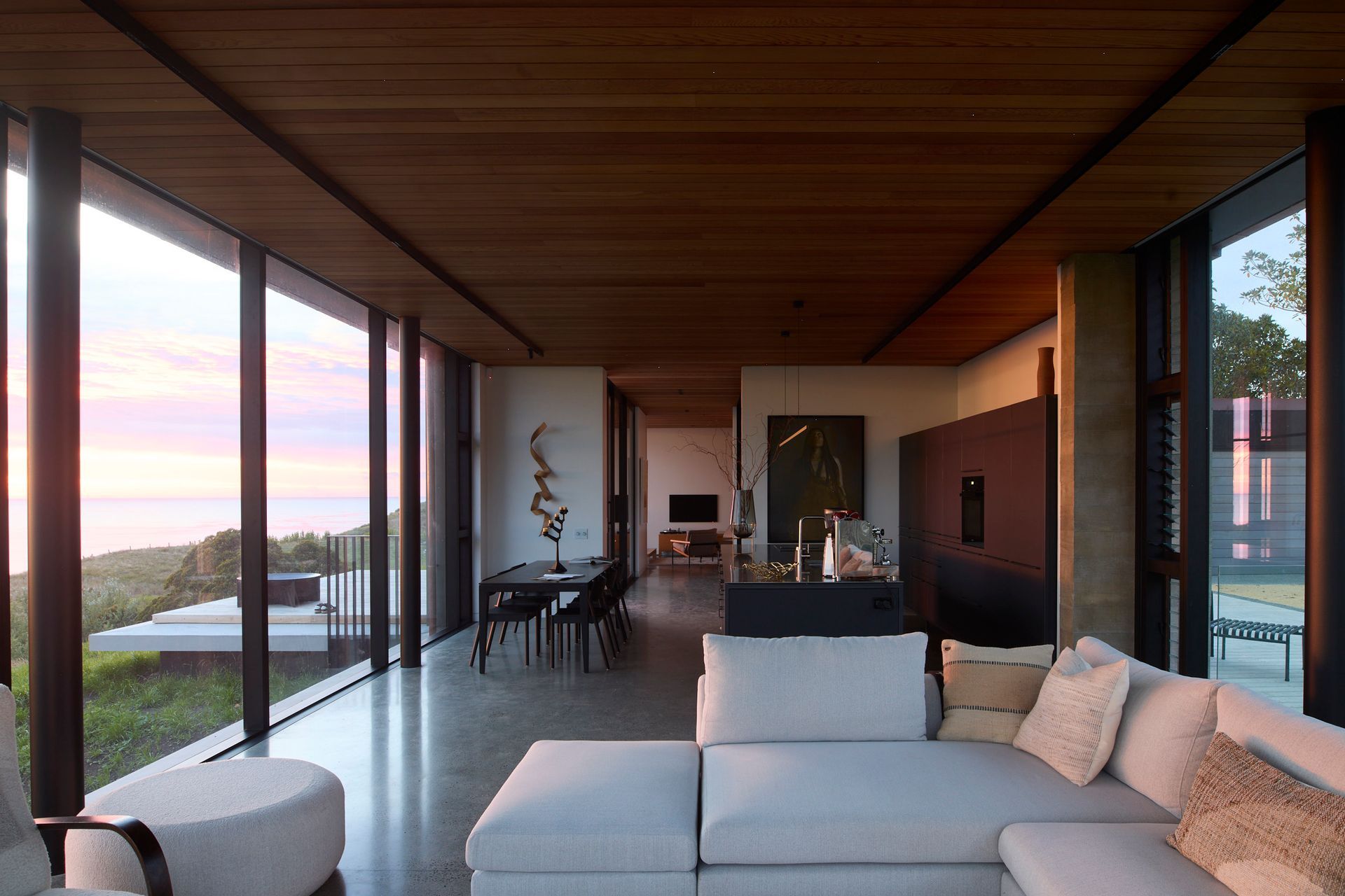 The living room invites light through all sides