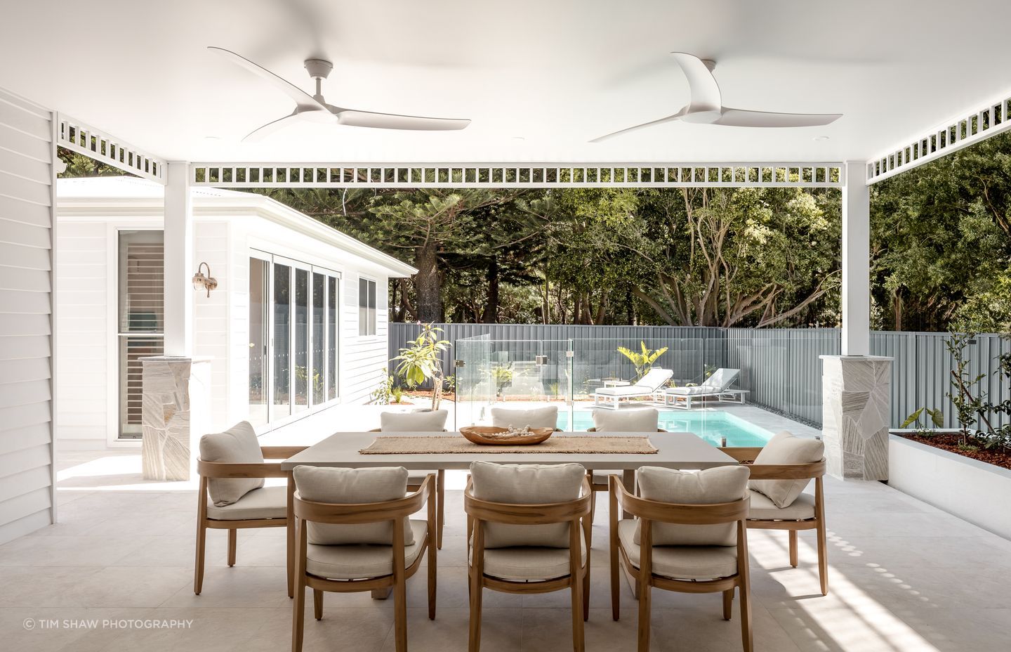 The detached pool cabana with gym overlooks the pool and outdoor dining.