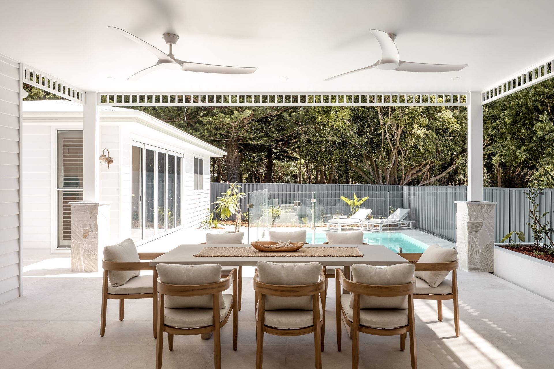 The detached pool cabana with gym overlooks the pool and outdoor dining.