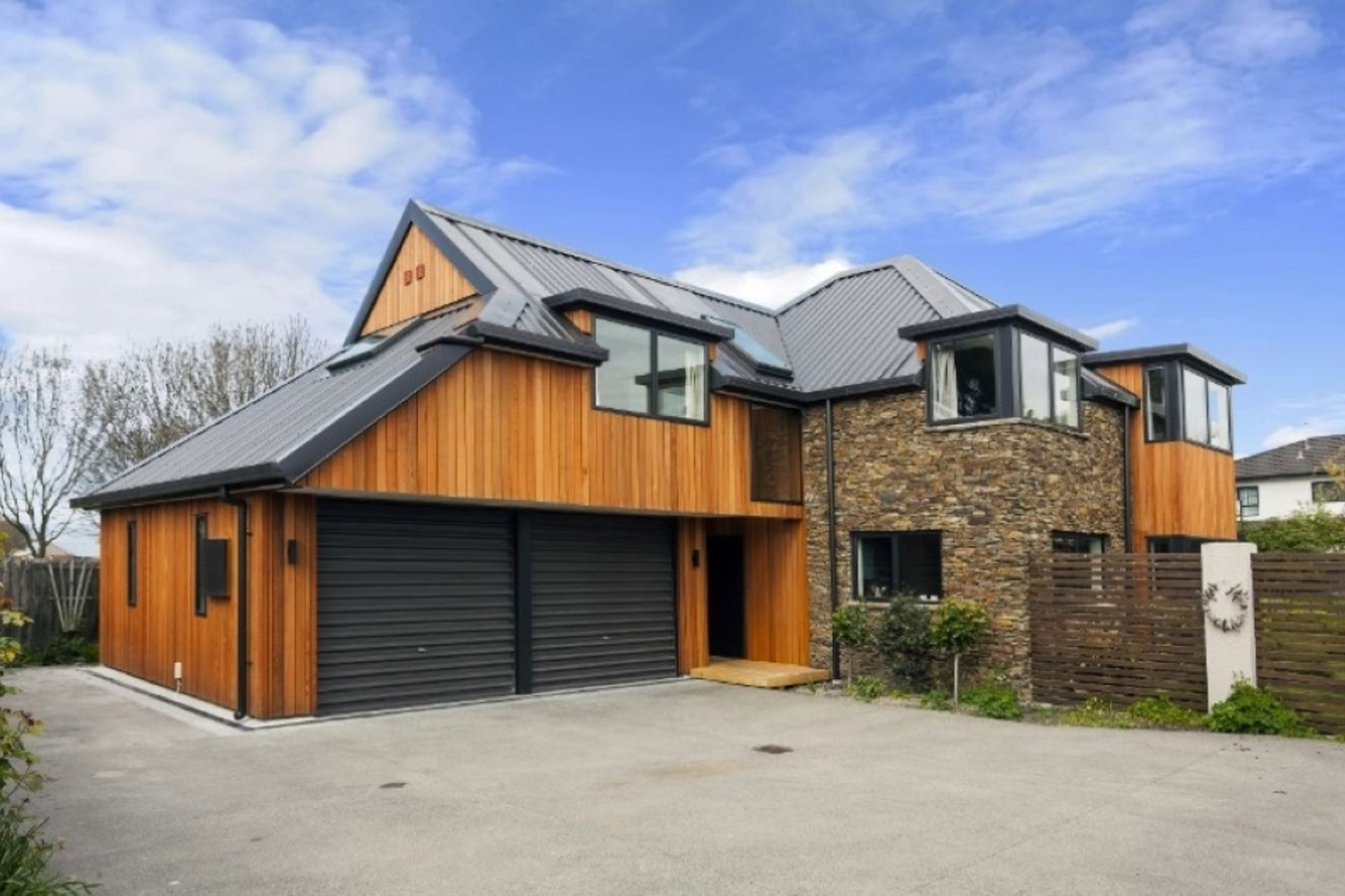 For this Higham Architecture exterior renovation, cedar was chosen for its visual warmth and natural harmony with schist. This was installed vertically to provide a balance in respect to the existing form of the house while adding a contemporary feel.