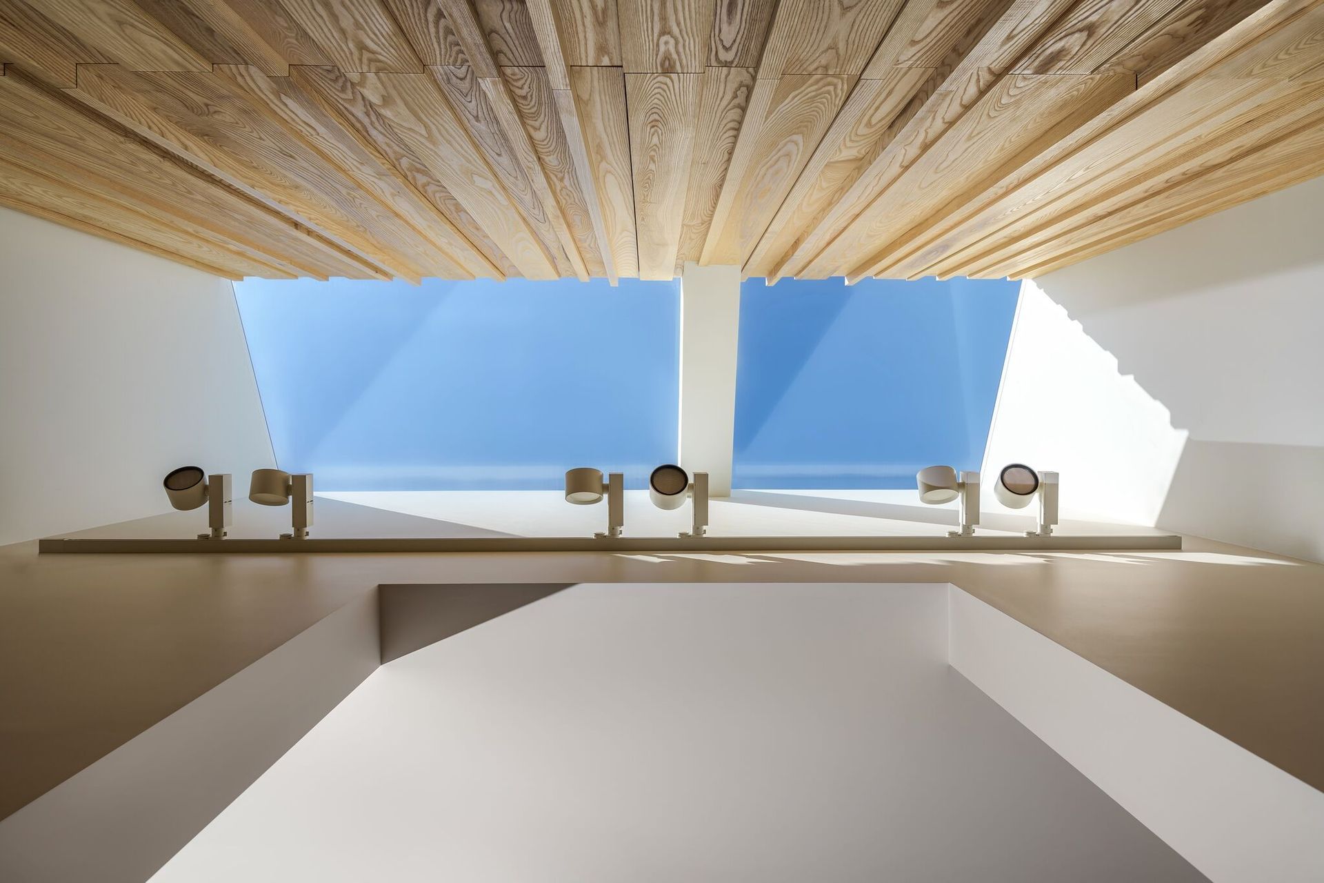 A skylight at Hawthorn House trickles sunlight down the walls, accentuating the pattern and texture in the timber panelling.