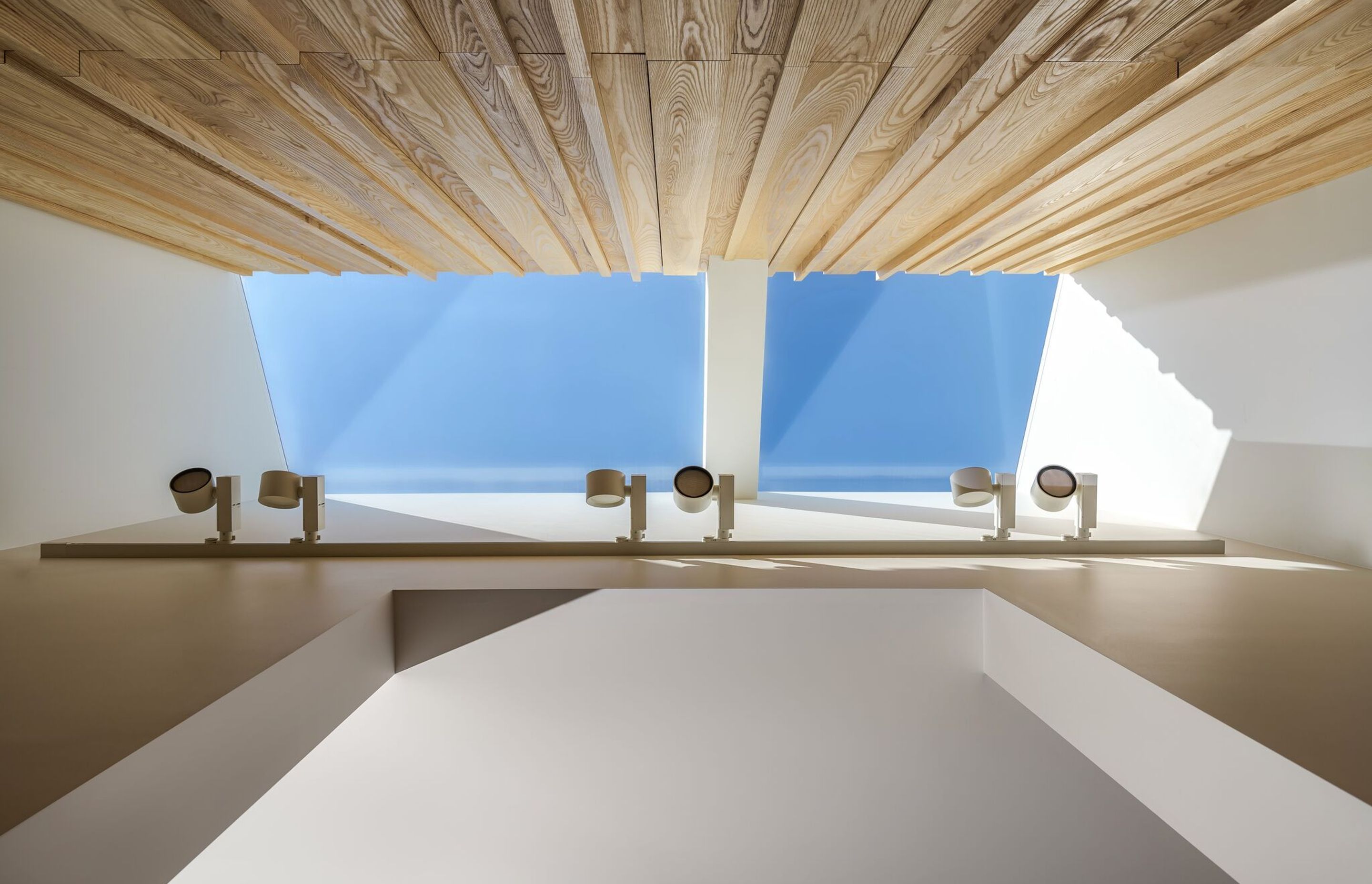 A skylight at Hawthorn House trickles sunlight down the walls, accentuating the pattern and texture in the timber panelling.