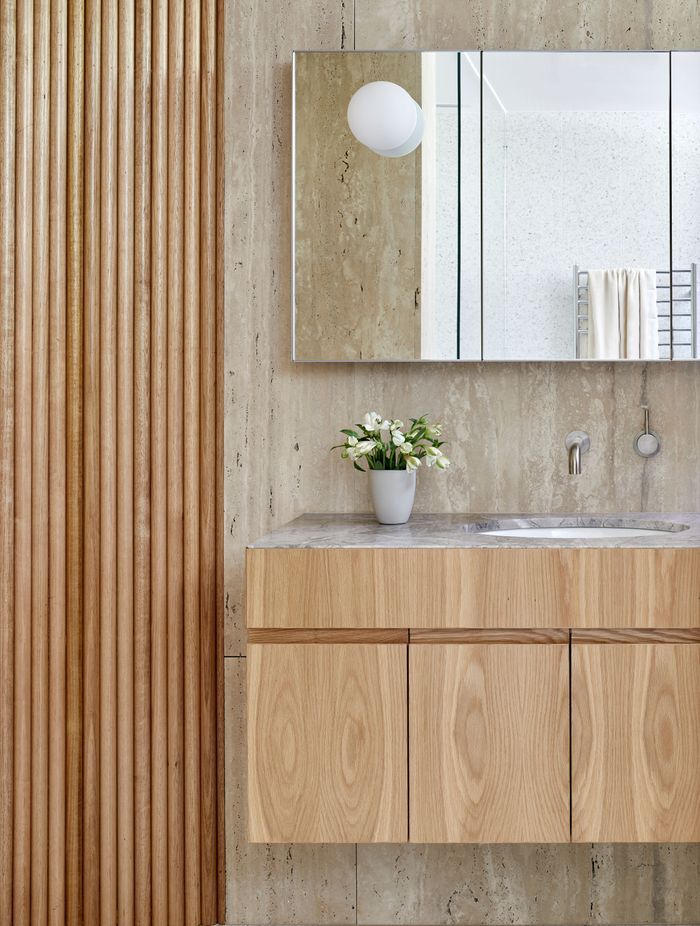 The bathrooms combine timber, terrazzo floor tiles, limestone and marble, bringing interest at every turn.